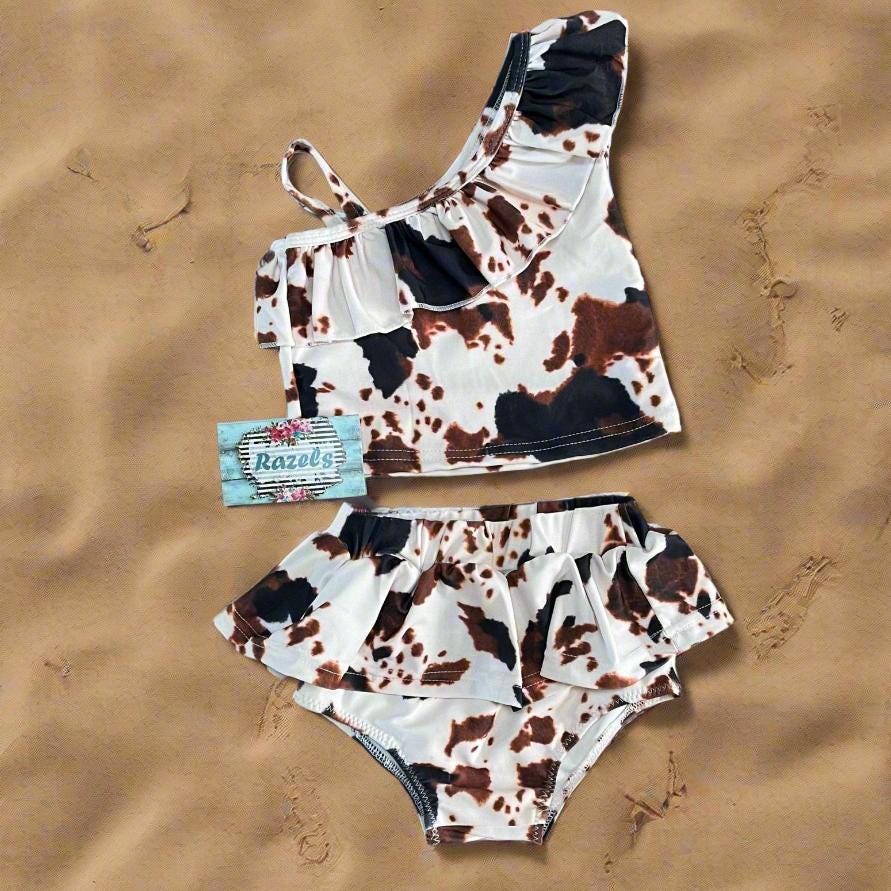 Cow Print Swim Suits are perfect for little cowboys and cowgirls!  Available Styles: Cow Print One-Piece, 2-piece tankini, or boys' Cowprint Shorts.Available in sizes 0-3 months to 8/9 years. Ship FREE with $35+ purchase.