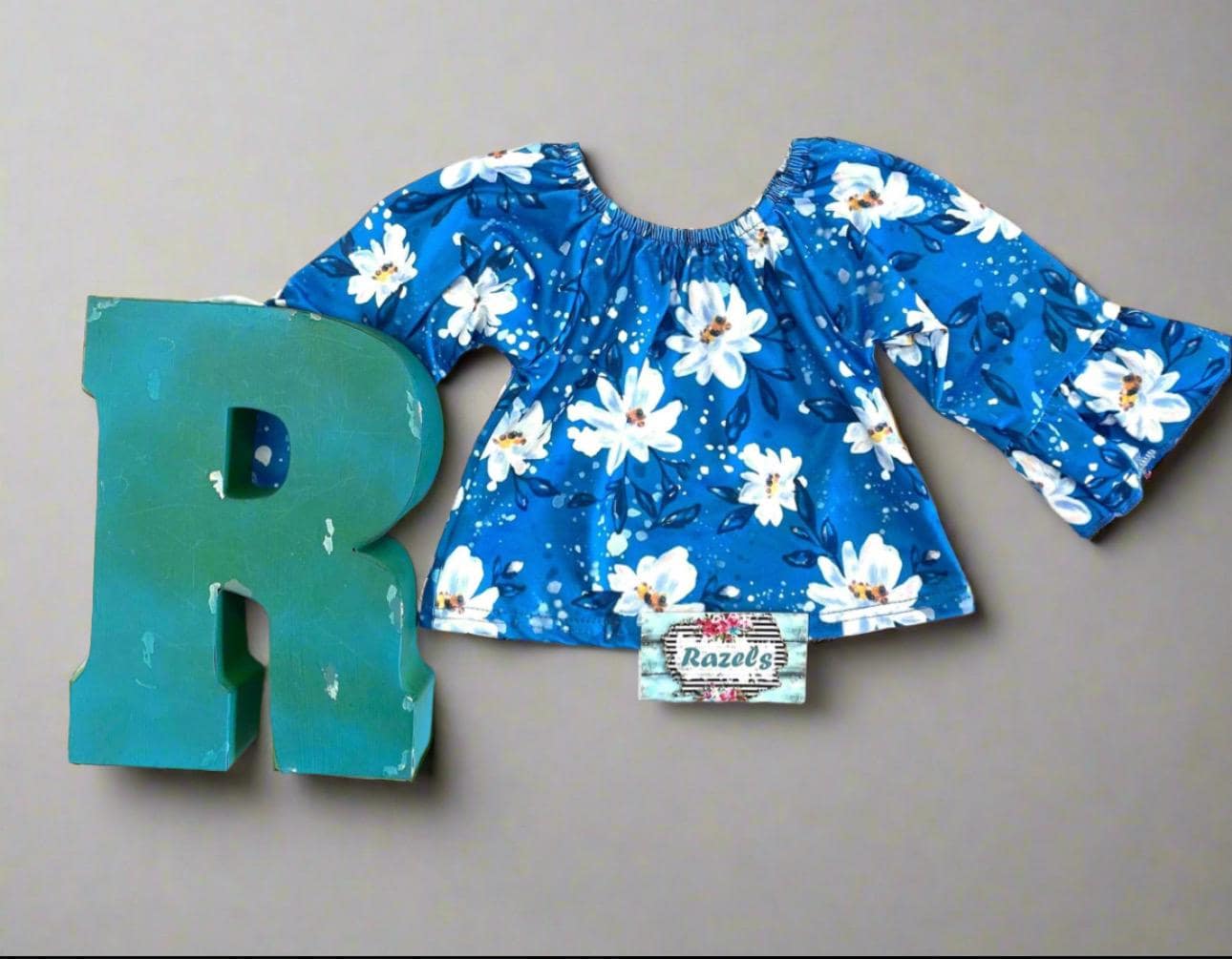 Get your little lady ready to shine this back-to-school season with our adorable Daisy Flower Blouse paired perfectly with blue and white striped bell bottom pants!
The blouse features a sweet daisy print with playful ruffled wrists that add just the right touch of charm. The bell bottoms bring a retro twist with their bold stripes and comfy stretch fabric that moves with her every step. FREE SHIPPING $35+