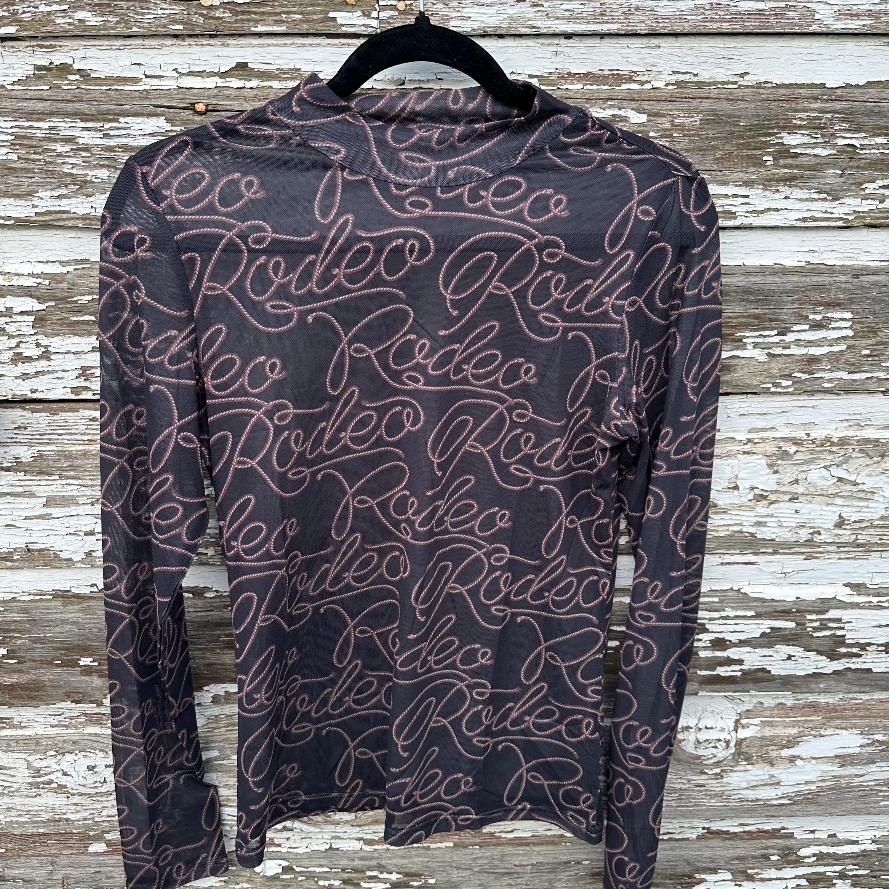Rodeo Shirt, Western SHEER Shirt, Rodeo Nights T-Shirt, Cowgirl Shirt, Layering Shirt
Turn heads on rodeo nights with this bold Western SHEER Shirt! This cowgirl shirt features a striking RODEO print on soft, breathable mesh—perfect for layering over your favorite Rodeo Nights T-shirt or wearing on its own. 
✔ Lightweight, breathable mesh for all-day comfort
✔ Stylish sheer design for layering or standalone wear
✔ Bold RODEO print for a statement Western look
FREE SHIPPING $35+ FROM MONTANA