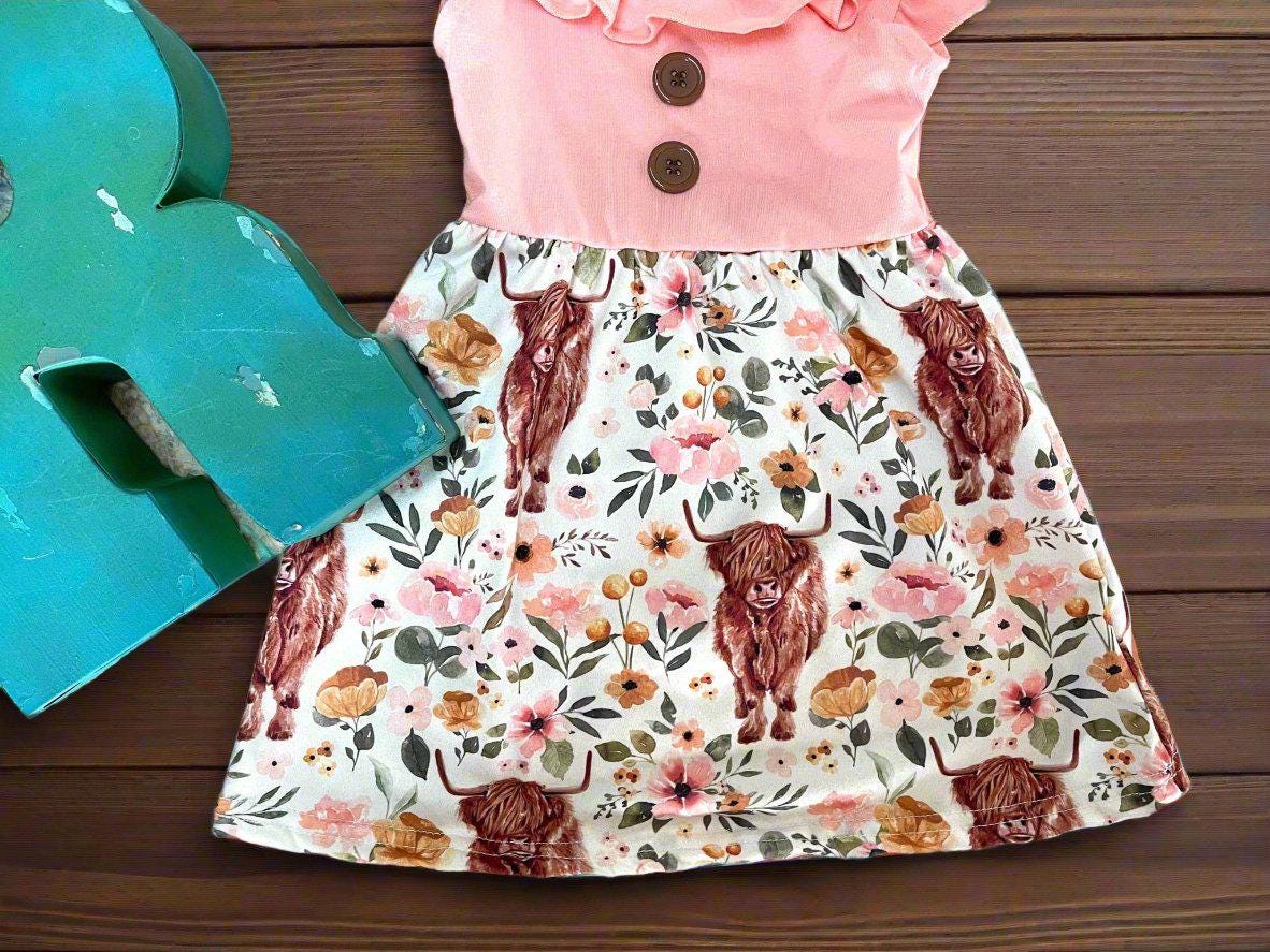 Scottish Highland Cow Dress! 🐄💖 It's the perfect blend of comfort and style, featuring a cute floral highlander cow print on the bottom. The soft top has flutter sleeves, a collar, and button details for an added touch of charm. Ships FREE with $35
