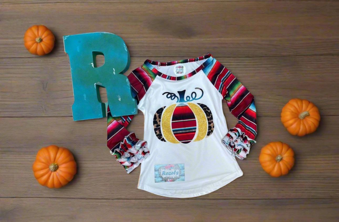 Fall Stripes Pumpkin Ruffle Sleeve Shirt. This Fall Shirt features a pumpkin with Fall serape stripes, cheetah print and glitter gold. The neckline and sleeves are festive serape stripes with wrist ruffles. So cute!