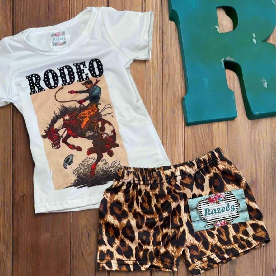**🐎 Fun Bucking Bronco Rodeo Outfit for Your Little Cowgirl! 🐎**
Let your little one **ride in style** with this **Girls' Cowgirl Outfit**, the perfect blend of Western charm and trendy fashion! Featuring a bold **Rodeo Shirt** with a playful bucking bronco design and stylish **Cheetah Shorts**, this **Girls' Western Outfit** is a must-have for summer rodeos, fairs, and everyday adventures.