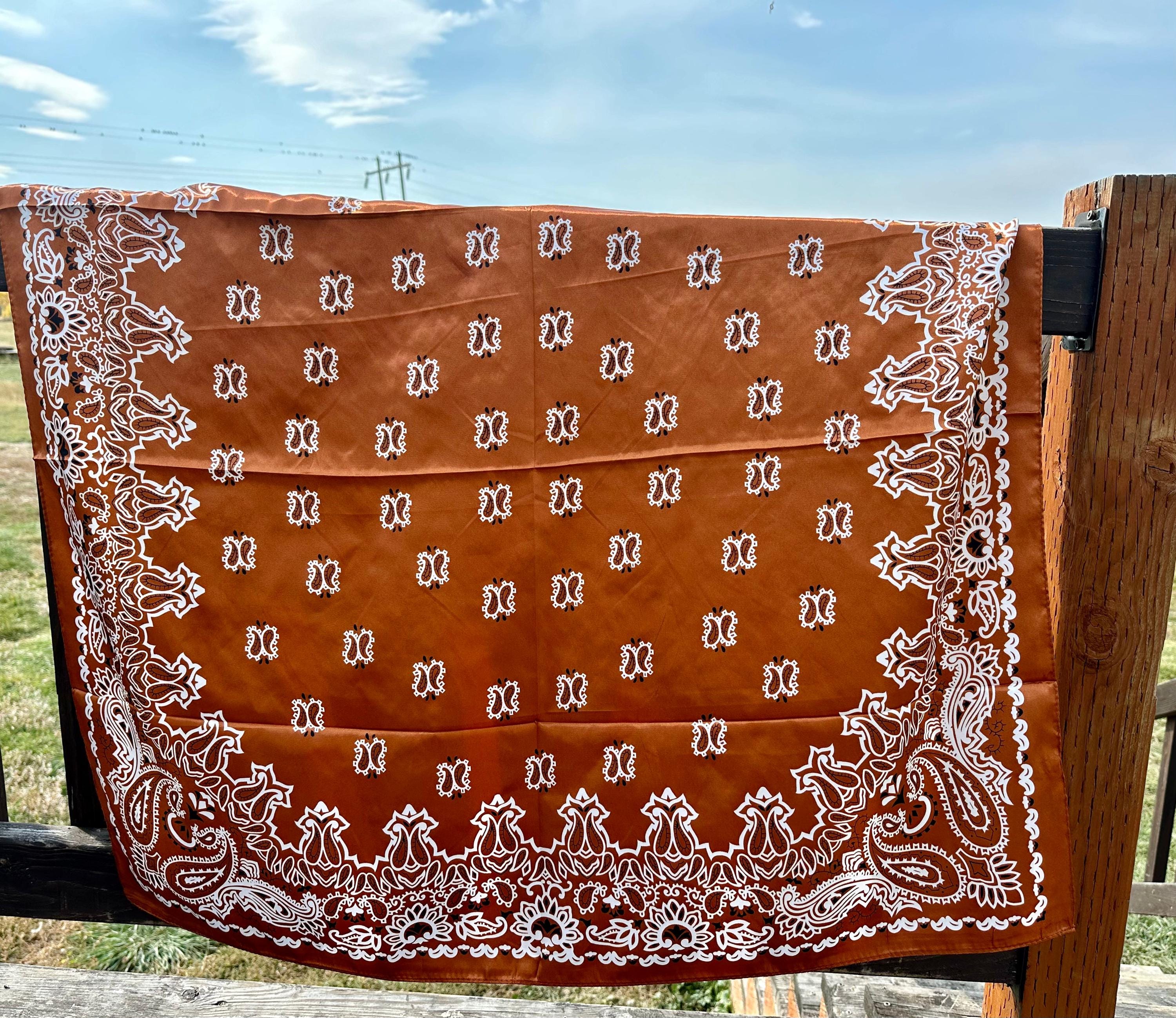 Elevate your style with this vintage-inspired paisley scarf, with a luxuriously soft feel. Measuring 35X35", this large square Wild Rag scarf offers endless styling possibilities, adding a touch of Western flair to any outfit.