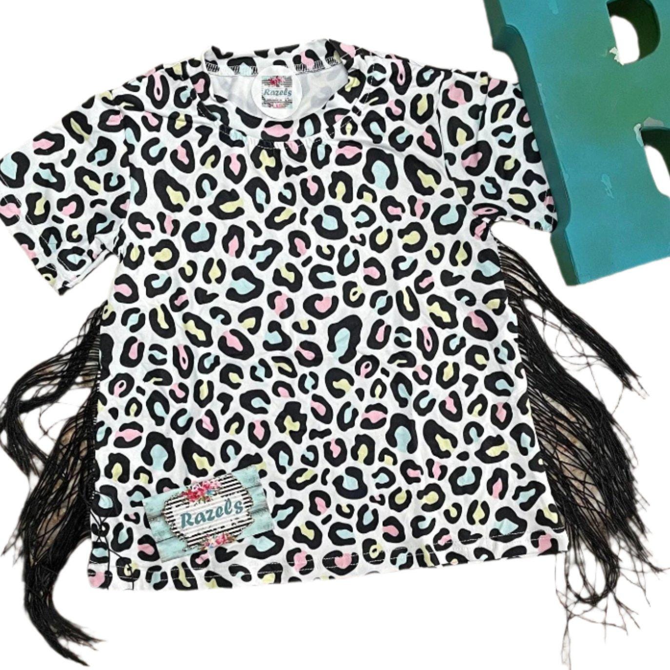 Get her twirling in this Cheetah Print Fringe Dress! Featuring a colorful animal print and boho fringe, this soft cotton blend t-shirt dress offers a true-to-size fit. Perfect for playful days or casual outings, it's machine washable and super comfy!