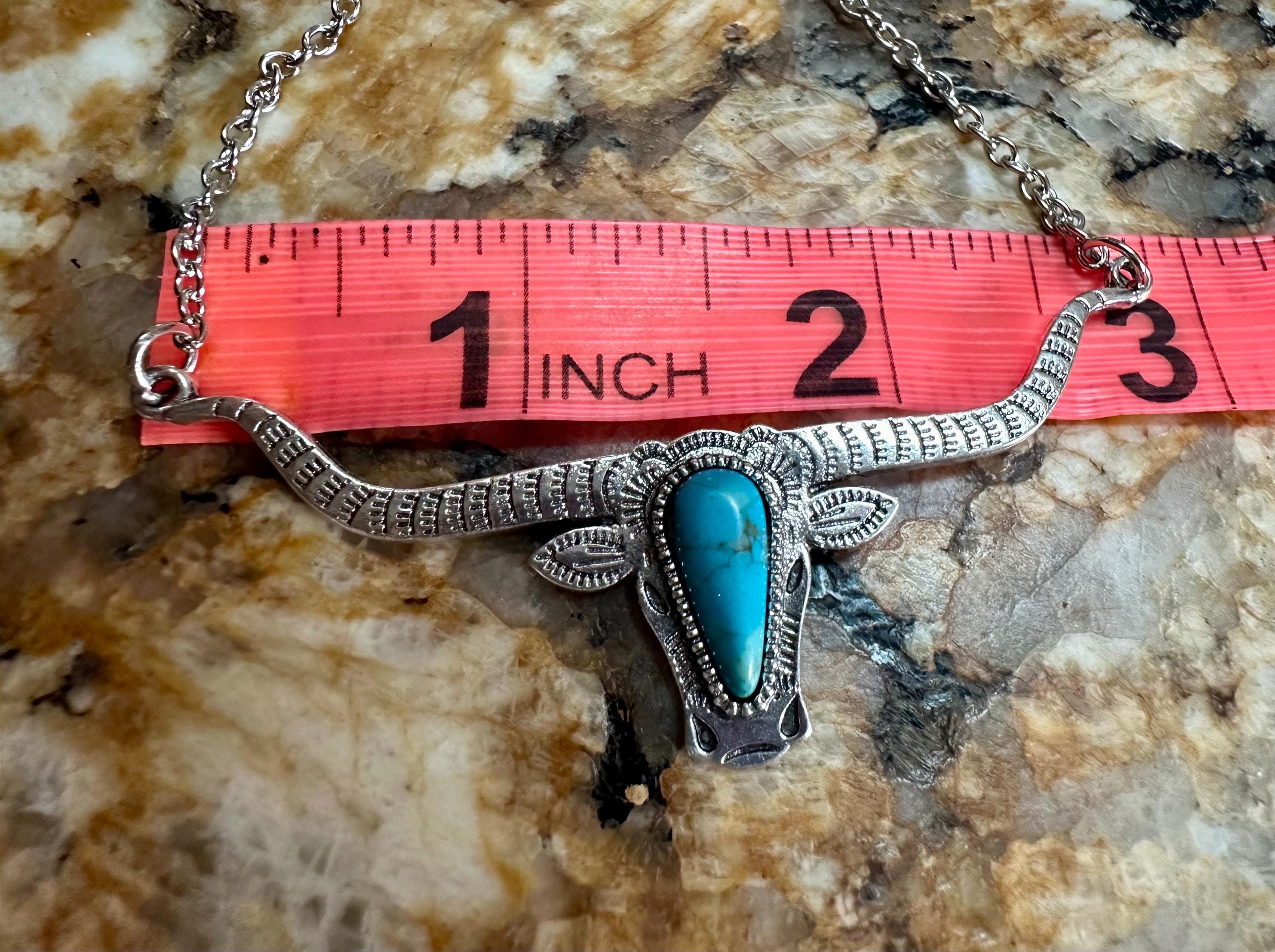 Bold and Beautiful: Split Chain Longhorn Necklace with Turquoise Stone. Embrace a bold, Western style with our stunning Split Chain Longhorn Necklaceādesigned for those who truly & grab life by the horns. Ships FREE with $35+ purchase