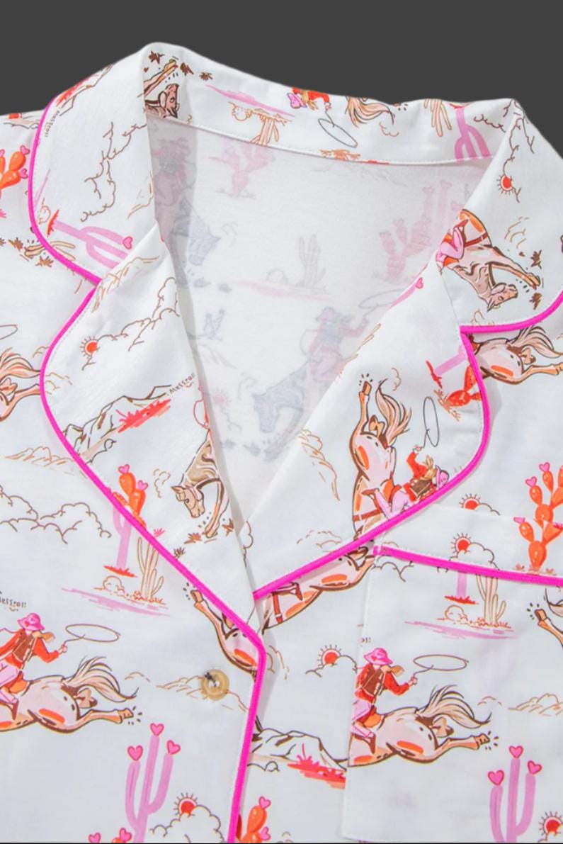 Pink Cowgirl Pajama Short Set š©·
How fun and cowgirl-tastic is this Cowgirl Pajama Short Set?! This Western Pajama Set is the perfect blend of comfort and style, featuring a button-up top with short sleeves and matching shorts with pockets. Perfect summer cowgirl pajamas for a bridal shower or birthday gift. The playful cowgirl print showcases cowgirls doing their cowgirl thing, with hot pink piping, a drawstring, and pink and orange cacti details. SHIPS FREE from MONTANA today.
