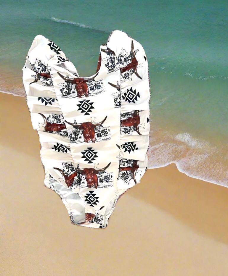 Western Swimsuits – Longhorn Steer Sibling Swimsuits. Get ready for summer with these Matching Swimsuits featuring a bold Longhorn Steer design! This black-and-white desert scene with a geometric touch is perfect for little cowboys and cowgirls who love Western style. 
 Cowboy Swim Trunks: Unlined for comfort, with a functional drawstring—also great as stylish day shorts!
Cowgirl Swimsuit: An adorable one-piece swimsuit with front ruffles fit for little rodeo queens!