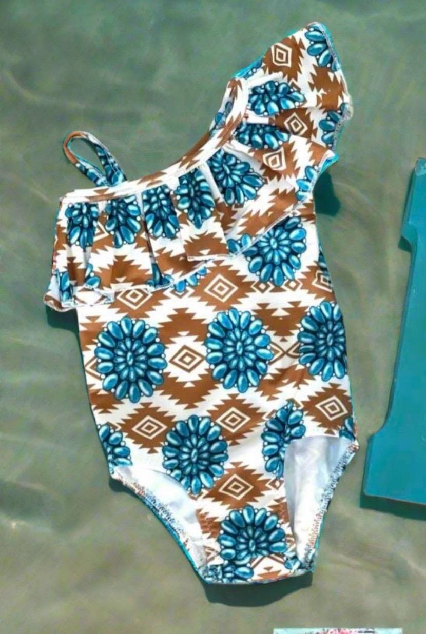 Cowgirl Swimsuit, Turquoise Conchos, Western Swimsuits, SOUTHWESTERN, Squash blossoms, Girls One piece swim, Ruffle Swimsuit, Girls' Western Swimsuit Two of our favorite things – Aztec prints and turquoise concho squash blossoms – come together in this stunning Western-inspired swimsuit! 😍 This girls' one-piece ruffle swimsuit is a must-have for little cowgirls who love bold, Southwestern style. Available 0-3 months - girls 12/14. Ships FREE $35+ order from Montana.