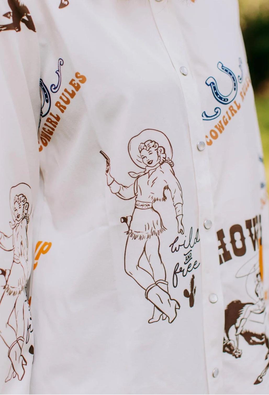 Women's Western Button-Up Shirt | Cowgirl Shirt with Retro Rodeo Vibes -This high-quality Western button-down shirt is a must-have for any cowgirl’s wardrobe! Made from 100% polyester, it offers a silky-soft feel, lightweight comfort, and all-day breathability—perfect for rodeos, nights out, or everyday Western wear.
✨ Why You’ll Love This Shirt:
✔️ Premium Fabric: Crafted from luxurious, high-quality polyester, this blouse is ultra-soft and smooth to the touch. SHIPS FREE from MONTANA toda