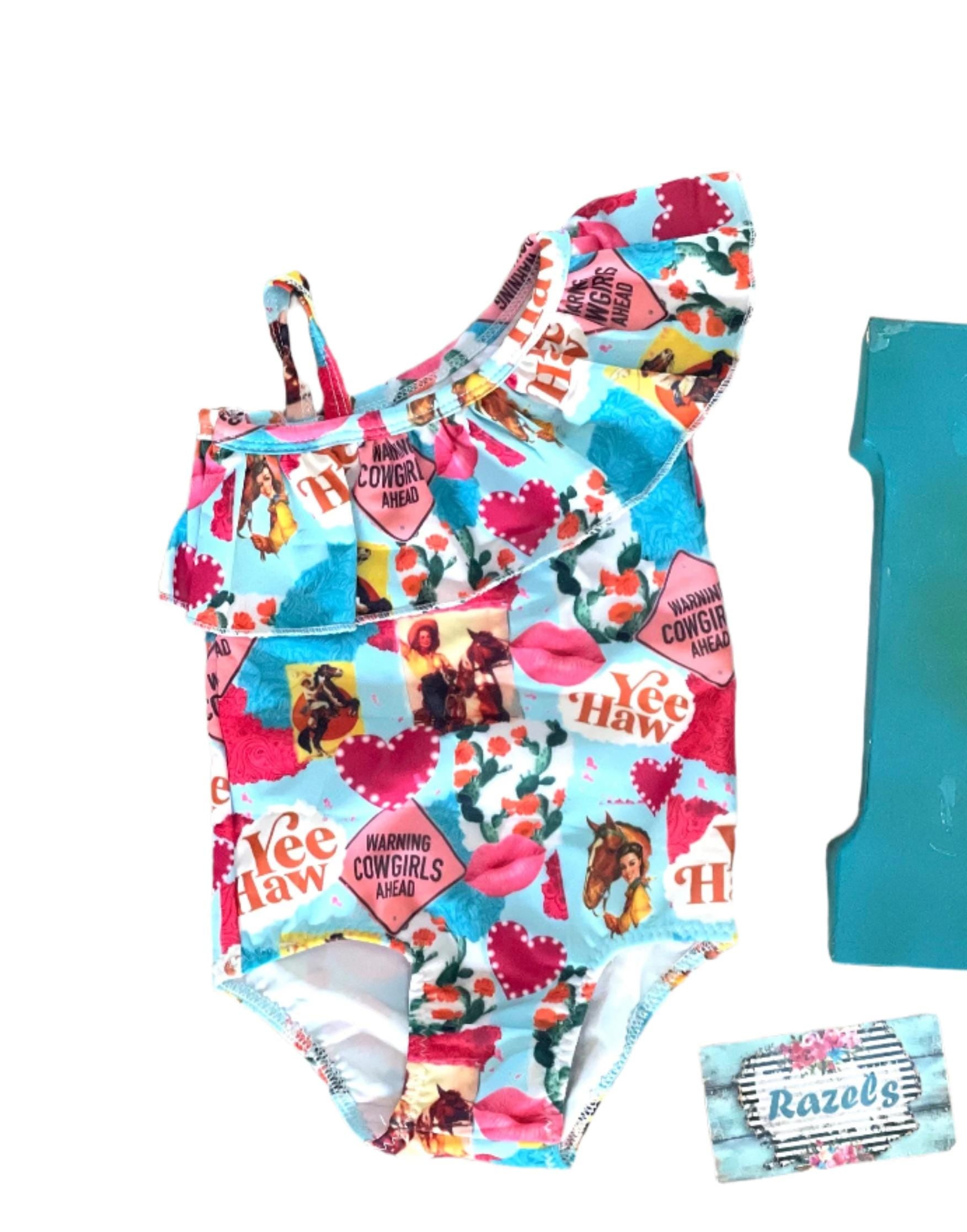 Yeehaw, Cowgirl Cutie! 🤠💗 This fun and fabulous Western Ruffled Swimsuit is perfect for little cowgirls who love adventure! Featuring a darling print of cowgirls riding horses, hearts, and cacti, this one-piece swimsuit is as cute as it gets. ✨ Why You’ll Love It: ✔️ Available in sizes 0-3 months to 8/9 – perfect for babies, toddlers, and big sisters! ✔️ Double-layered front for comfort and durability. ✔️ High-quality swimsuit material that’s made to last. 📦 FREE U.S. shipping on orders $35+