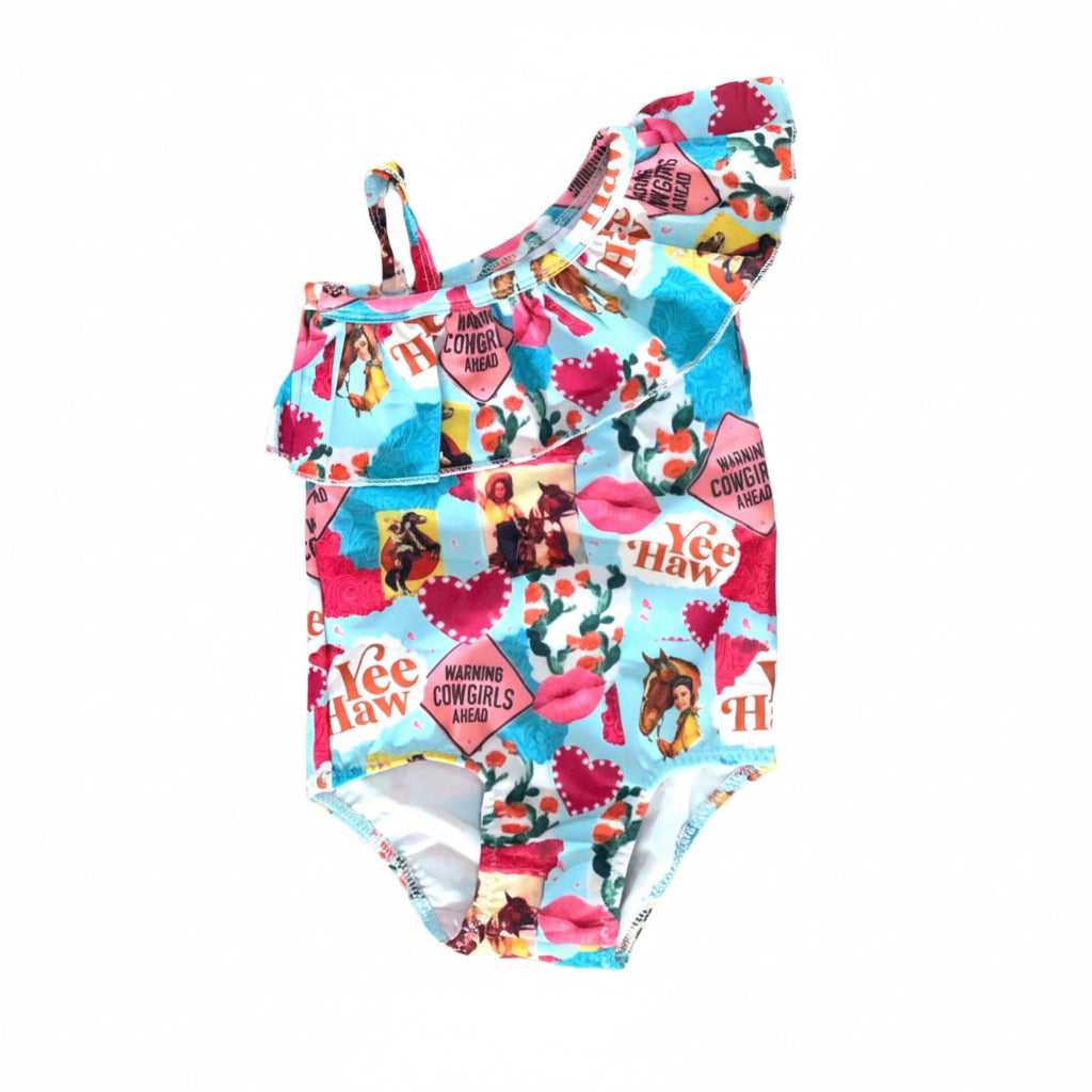 Yeehaw, Cowgirl Cutie! 🤠💗 This fun and fabulous Western Ruffled Swimsuit is perfect for little cowgirls who love adventure! Featuring a darling print of cowgirls riding horses, hearts, and cacti, this one-piece swimsuit is as cute as it gets. ✨ Why You’ll Love It: ✔️ Available in sizes 0-3 months to 8/9 – perfect for babies, toddlers, and big sisters! ✔️ Double-layered front for comfort and durability. ✔️ High-quality swimsuit material that’s made to last. 📦 FREE U.S. shipping on orders $35+
