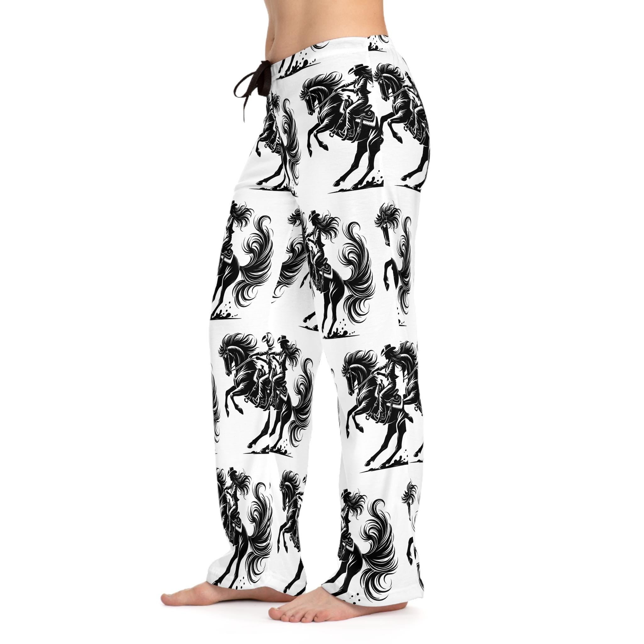 Black & White Cowgirl Print Pajama Pants – Bold Western Lounge Vibes 🖤🐎
Make a statement, even in your PJs. These black-on-white lounge pants feature a striking allover print of a fearless cowgirl riding her rearing horse—hair, mane, and tail flying with wild energy. It’s Western art in motion, wrapped around the most comfortable pants you'll ever own.
Perfect for girls trips, horse birthday gift or any cowgirl who rides bold—even in her dreams.