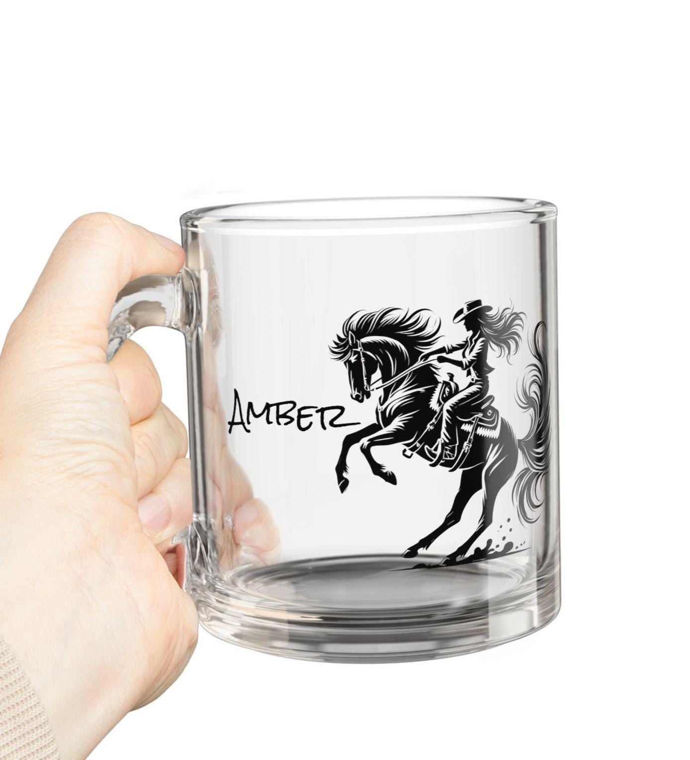 Saddle up your morning routine with this Wild Cowgirl Glass Mug! Featuring a bold cowgirl riding her rearing horse, this 10oz clear glass mug is perfect for coffee, tea, or even a little evening wine with Western flair. It’s sleek, sturdy, and shows off your love for the cowgirl life in the most stylish way.
✅ 10oz capacity – perfect for coffee, tea, or cocoa
✅ Heat-resistant clear glass with a clean, modern look
✅ Comfortable handle for easy sipping
✅ Made to order with your personalized to