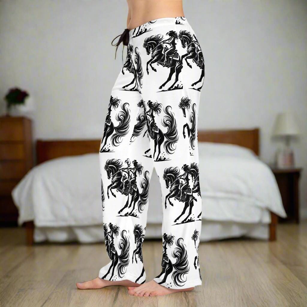 Wild Cowgirl Pajama Pants ā Bold Western Lounge Vibes
Perfect for bachelorette parties, horse lovers, or any cowgirl who rides boldāeven in her dreams. Wear them as pajamas, loungewear, or throw on a hoodie and boots.
100% polyester jersey knit ā soft, lightweight, and made to move
Relaxed comfort fit with a flowy silhouette
ā
 Bold all-over cowgirl & horse print ā black on crisp white
 Back elastic waistband + black drawstring for a custom fit
 Tagless comfort with a sewn-in care label