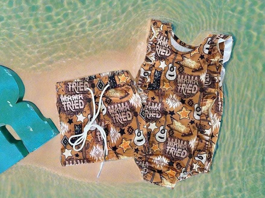 High quality, matching WESTERN swimsuits for kids, featuring Mama Tried print with allover Mama Tried, Cacti, Arrows, Stars and Guitars in a country brown. Sibling Swimwear is available in boys swim trunks and girls ruffle bathing suit.
