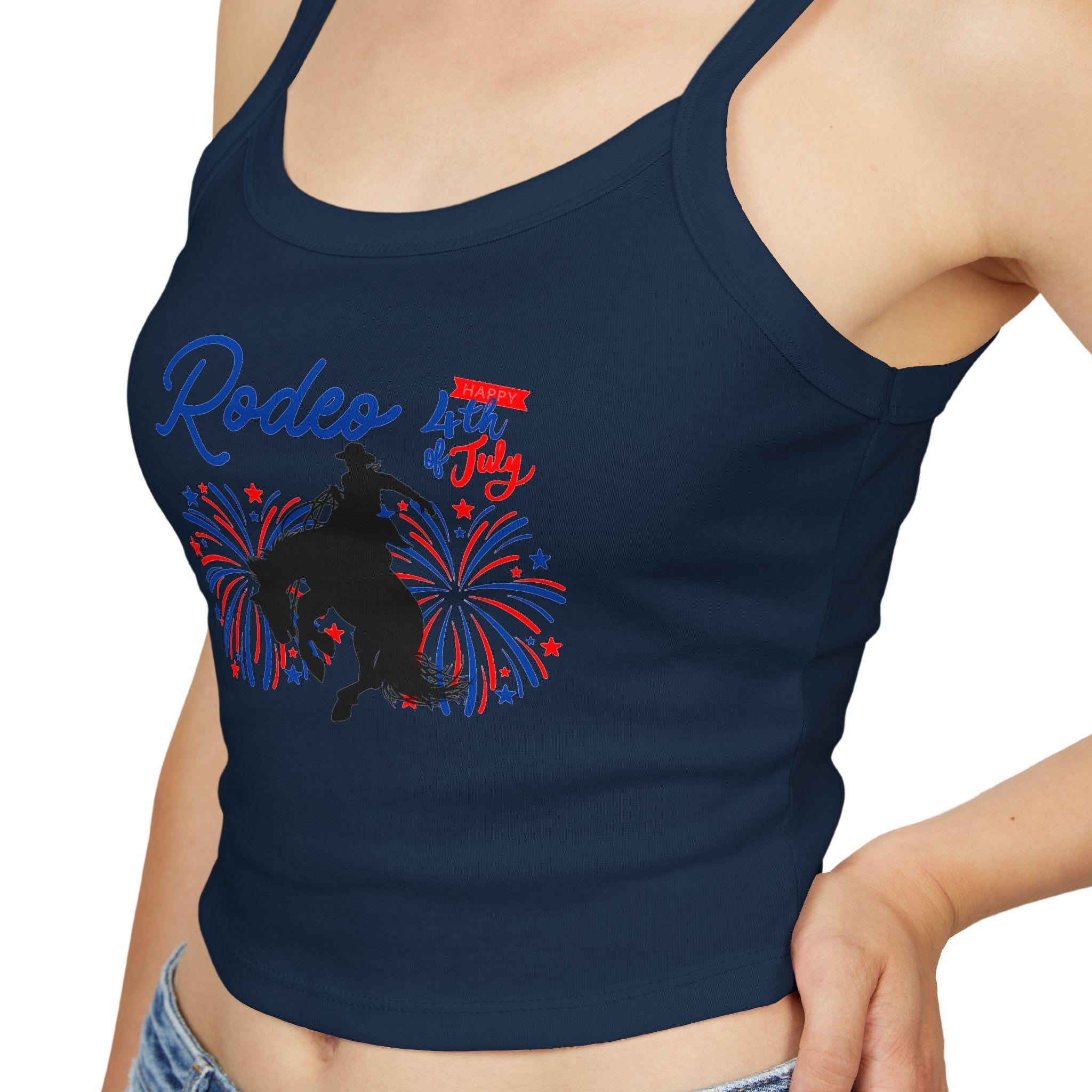 Rodeo Crop Tank – Bronc Rider & Fireworks for the 4th of July
Celebrate Independence Day with a little rodeo flair! This cropped spaghetti strap tank features our bold bronc rider silhouette bursting through red, white, and blue fireworks—perfect for cowgirls who love freedom, fashion, and a little yeehaw energy 🤠🎆
Made from a buttery-soft cotton blend with supportive thick straps, it’s made for sunny parades, backyard BBQs, or dancing under fireworks.