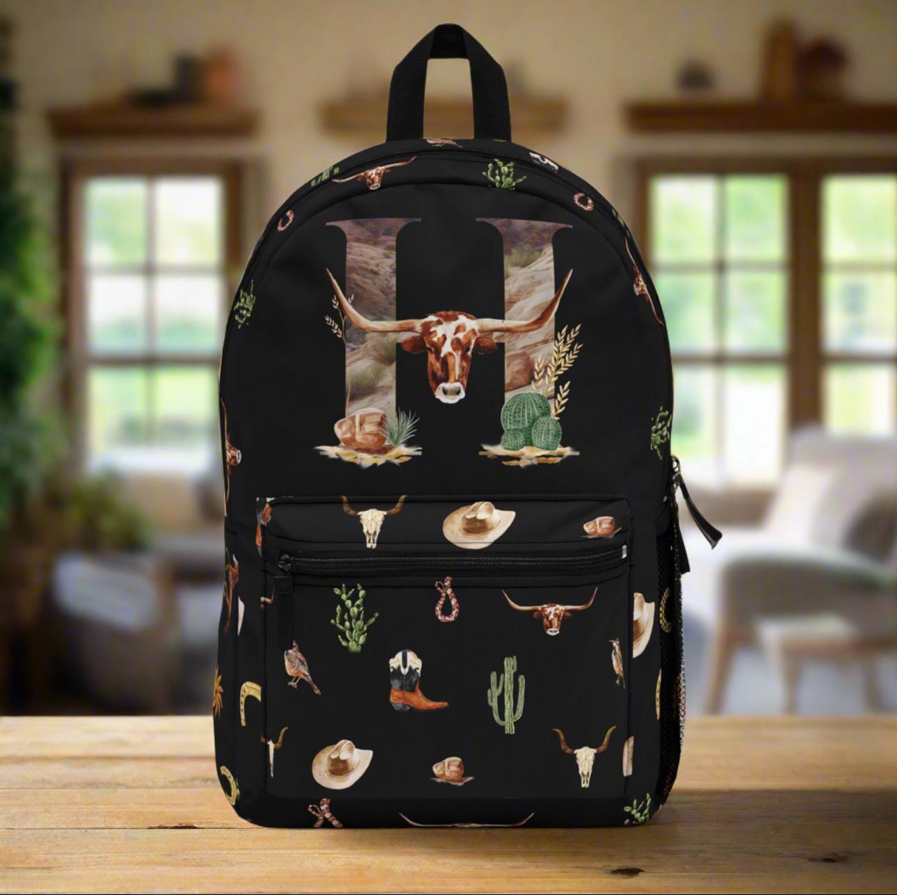 Personalized Western Cowboy Backpack | Custom Initial 
Perfect for back to school, travel, rodeos, or everyday adventures, this backpack blends style, durability, and organization.
✓ Allover Western motif – boots, skulls, snakes, horses & more
✓ Personalized with your initial
✓ 100% durable polyester – lightweight & quick-drying
✓ Padded back panel & straps for all-day comfort
✓ 4 roomy compartments + laptop sleeve for easy organization
✓ Heavy-duty zippers keep belongings secure