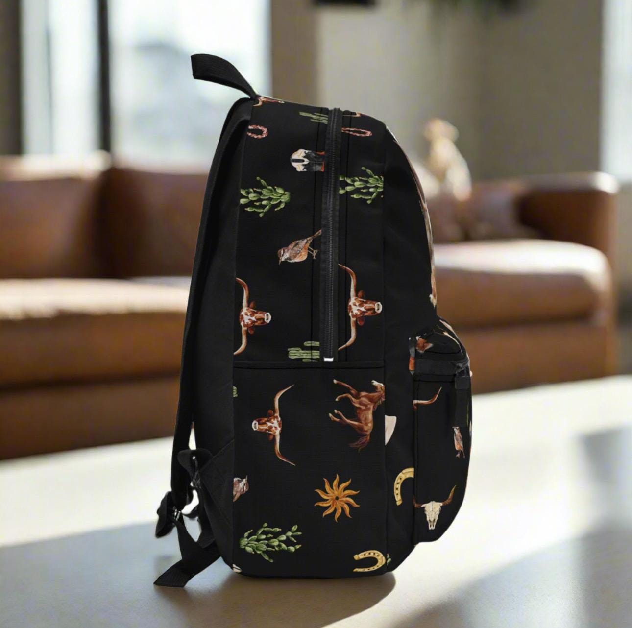 Personalized Western Cowboy Backpack | Custom Initial 
Perfect for back to school, travel, rodeos, or everyday adventures, this backpack blends style, durability, and organization.
✓ Allover Western motif – boots, skulls, snakes, horses & more
✓ Personalized with your initial
✓ 100% durable polyester – lightweight & quick-drying
✓ Padded back panel & straps for all-day comfort
✓ 4 roomy compartments + laptop sleeve for easy organization
✓ Heavy-duty zippers keep belongings secure