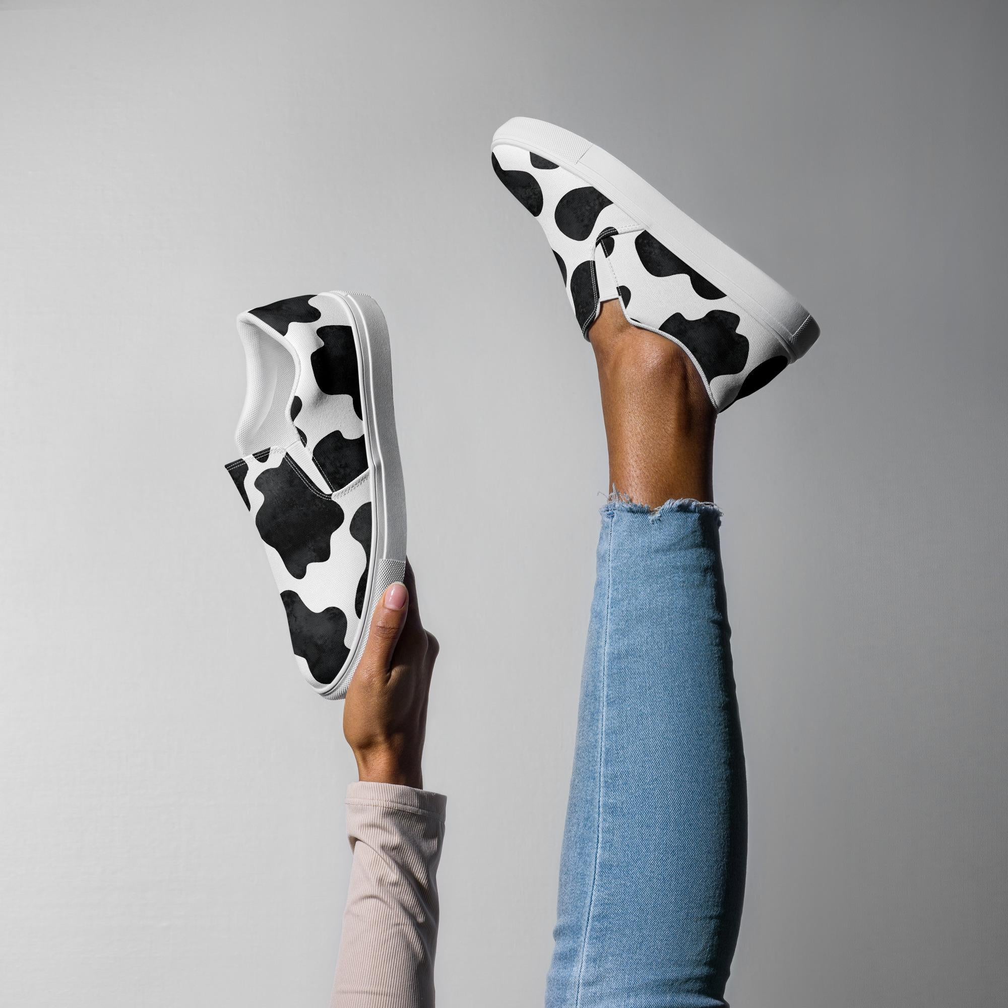 Cowprint Women’s Slip-On Shoes | Black & White Western Canvas Kicks  These black and white slip-on canvas shoes are the perfect blend of bold Western vibes and all-day comfort. Whether you're pairing them with denim cutoffs or your favorite dress, they're ready to moooove with you. ✓ Elastic side accents for easy on/off
✓ Breathable lining + soft removable insole
✓ Padded collar and tongue for added comfort
✓ Razels branding on the box, tongue & insole
✓ Printed, cut & handmade with care