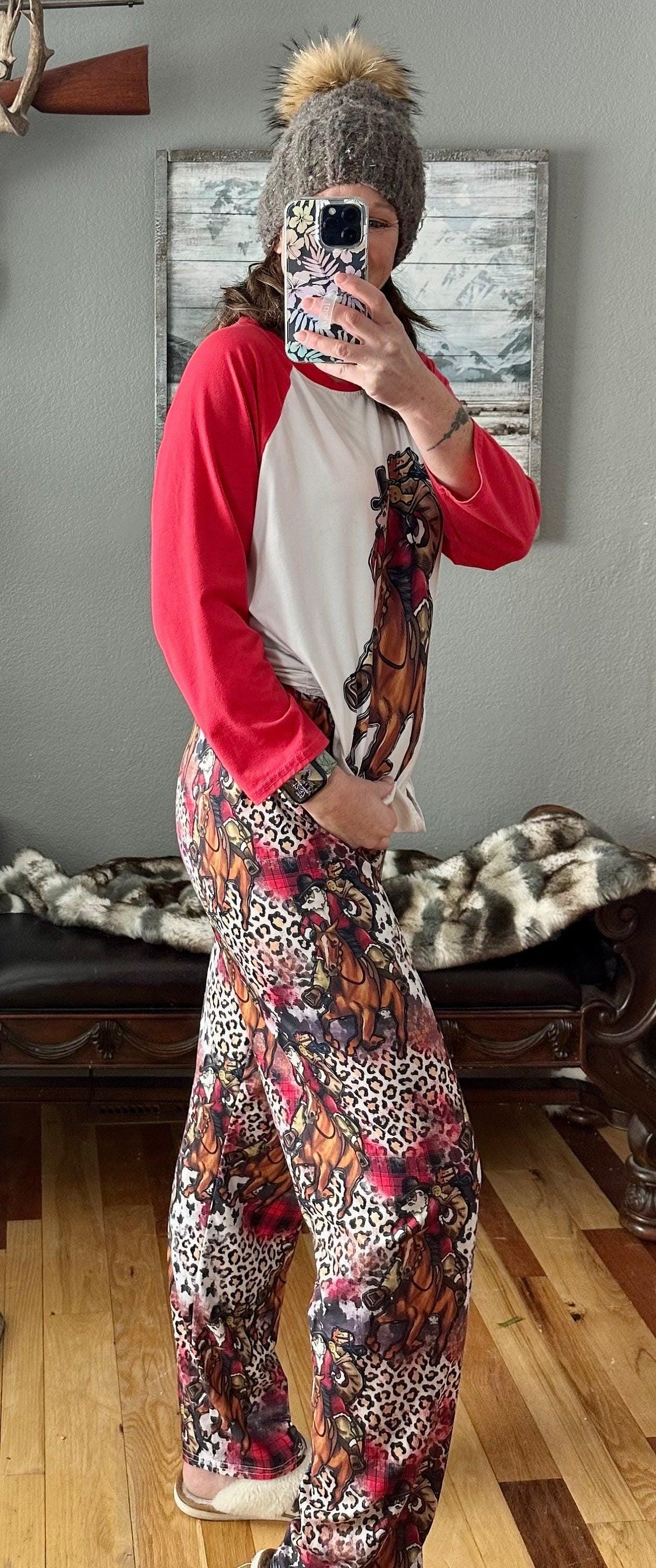 Cowboy Christmas Horse Family PJs with baseball t-shirt featuring Cowboy Santa delivering packages on his best horse, and Santa Jingle horse and cheetah print cover the comfy lounge pants. Cowprint Slippers are also available.