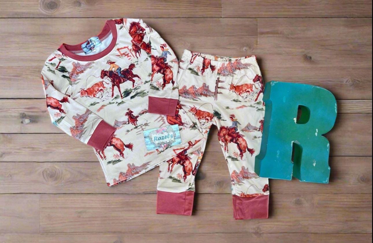 Kids Cowboy Pajamas are a Razels exclusive—featuring a vintage-style Western print with bucking broncos, roping cowboys, and rodeo action galore!
✓ Vintage Rodeo-Inspired Print – broncs, lassos, and cowboy flair
✓ Super Soft Cotton-Spandex Blend – c