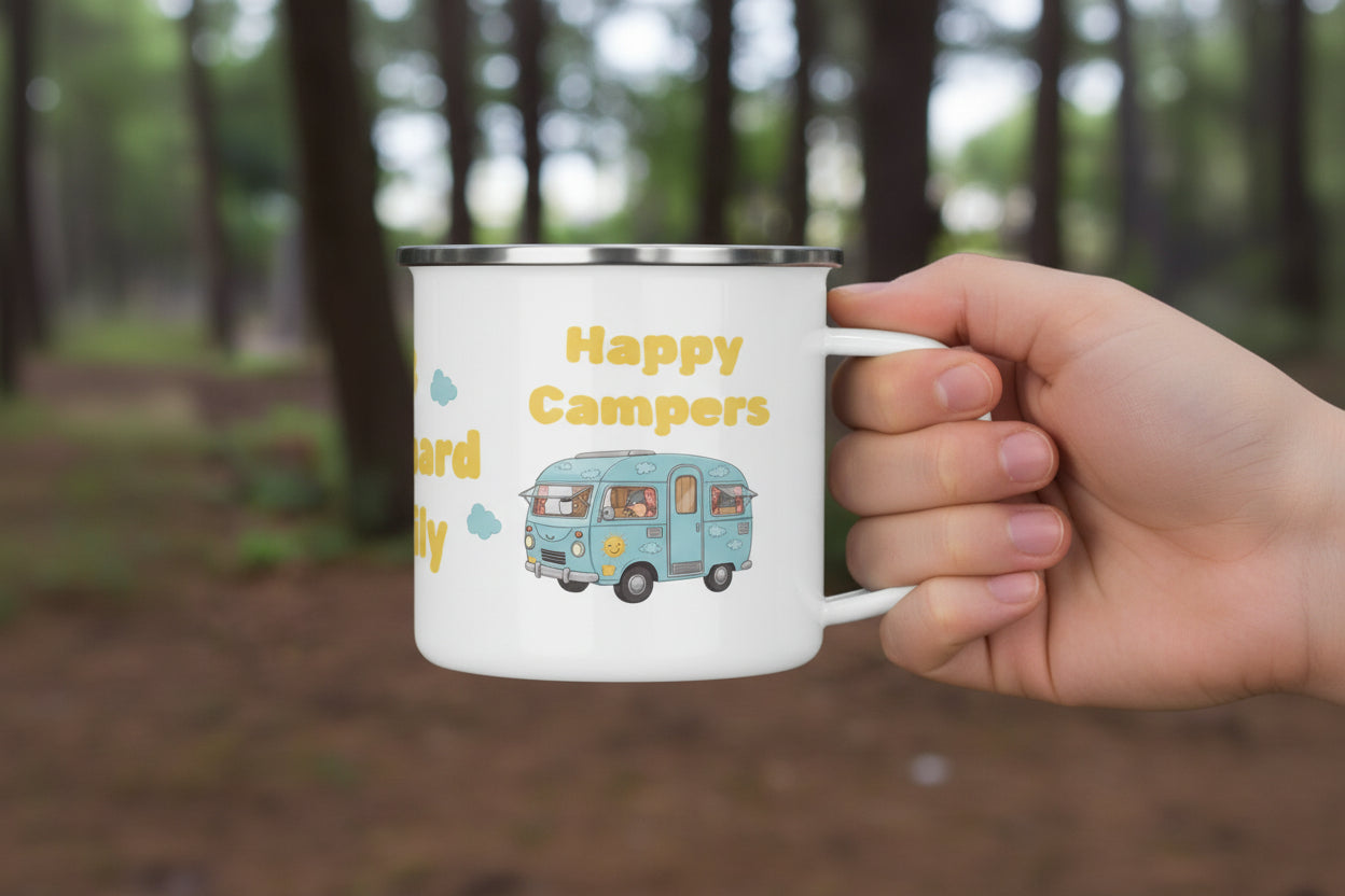 Mug with 'Happy Campers' text and camper van illustration on a wooden surface with a forest background.
