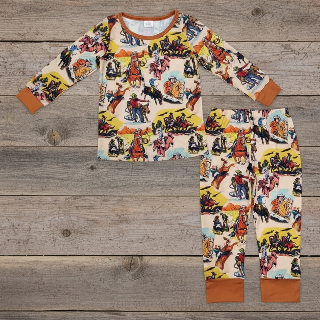 Children's pajama set with cowboy print on a light gray background