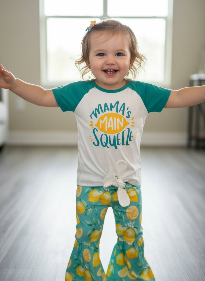 🍋 Mama's Main Squeeze Bell Bottom Outfit - a cheerful lemon-themed outfit! This adorable set features a playful "Mama's Main Squeeze" t-shirt and bell bottoms with an all over lemon print, adding a burst of sunshine to any day.