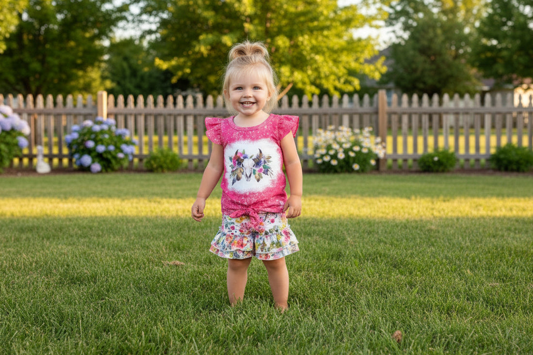 This Cowgirl BOHO Short Set is sweet, sassy, and full of Western charm — perfect for your little rodeo princess! The soft bleach-splattered ruffle sleeve tee features a bold cow skull with colorful flowers, a trendy tie-front hem, and boutique-quality detailing. Paired with matching ruffle shorts in a beautiful all-over floral print, this outfit is made for both style and play.
✓ Adorable Western boho design for girls, toddlers, and babies
