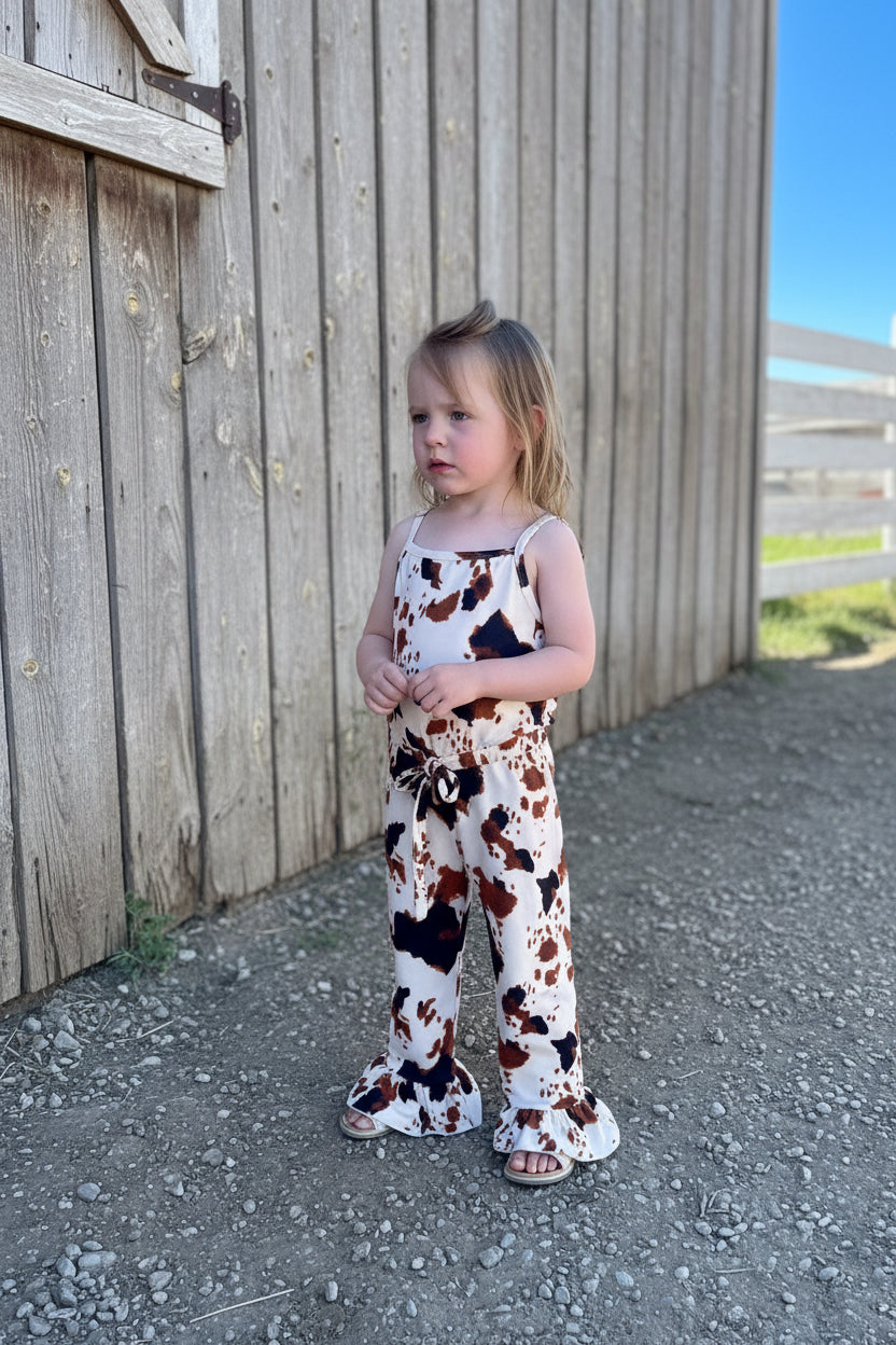 Adorable Cow Print Jumpsuit Romper for girls! Soft cotton/spandex blend, comfy slip-on style with elastic waist, machine washable. Available from 0/3 months to 8/9. Ships today from Montana! Perfect COWGIRL ROMPER for all day and special occasions.