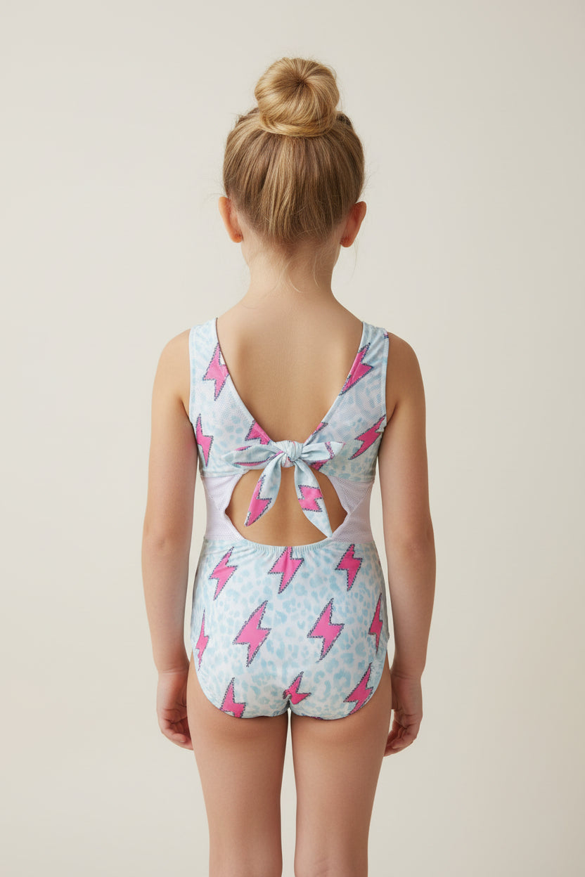 Pink Lightning Bolt One- piece Swimsuit is a Turquoise Cheetah Print One-Piece swimsuit featuring a striking pink lightning bolts and turquoise cheetah print design with a tie-back detail. Available in sizes 0/3 months to 8/9 years. Ships FREE $35+