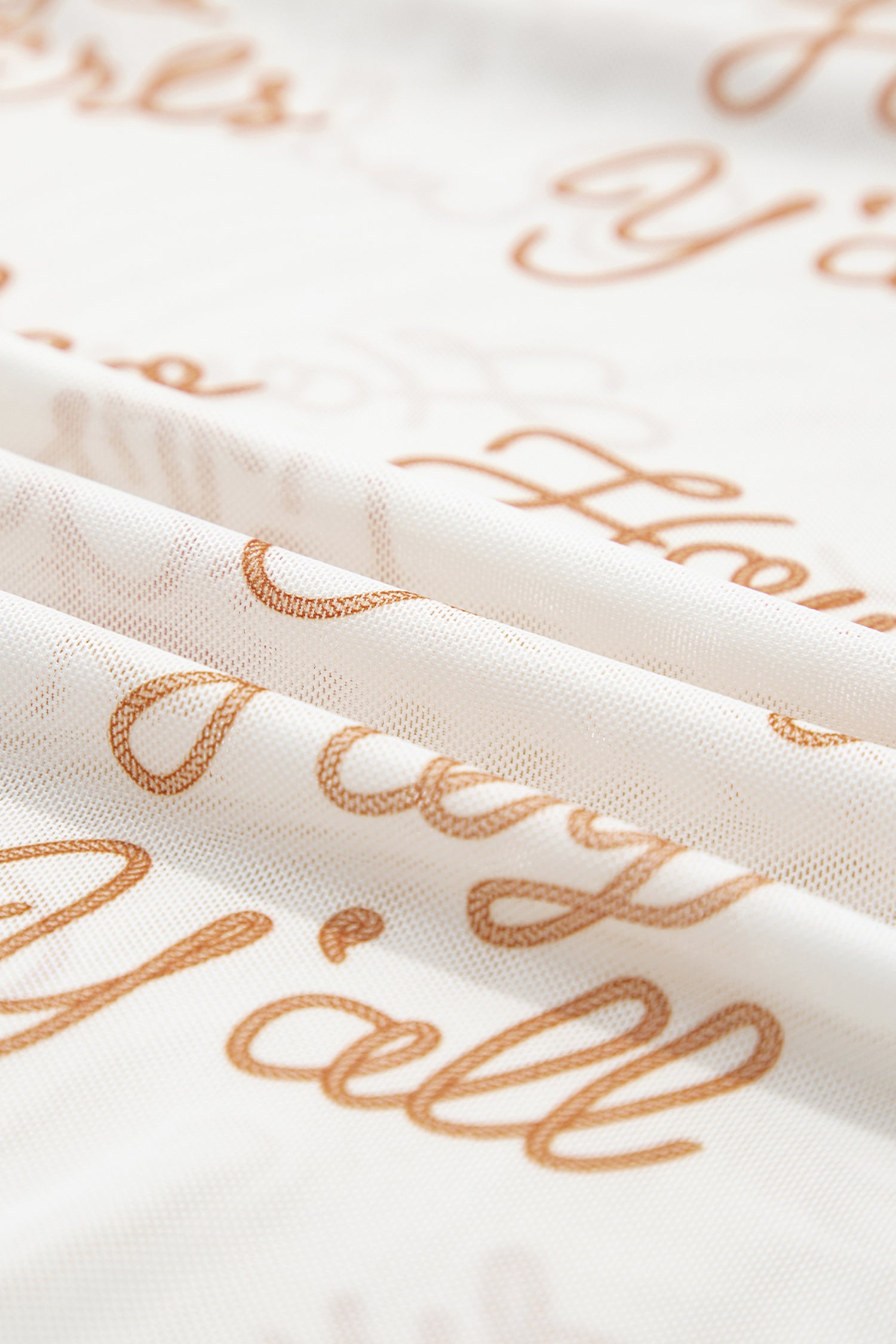 Close-up of fabric with western text pattern on a white fabric