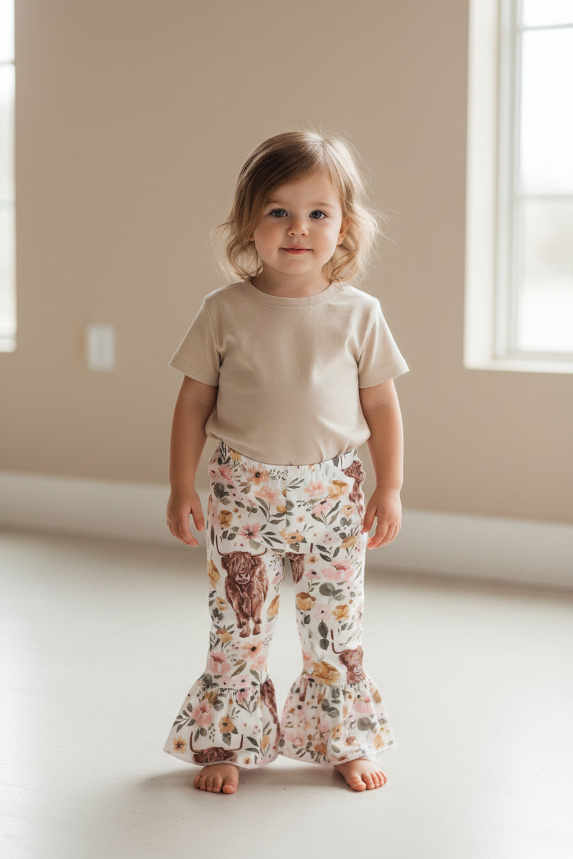 Highland Cow Floral Bell Bottoms – Adorable Western Cow Pants for Little Cowgirls! Featuring a whimsical design of Highland cows and florals, these Western bell bottoms have a soft, stretchy fit and a fabulous flare! Comfortable and Cute!