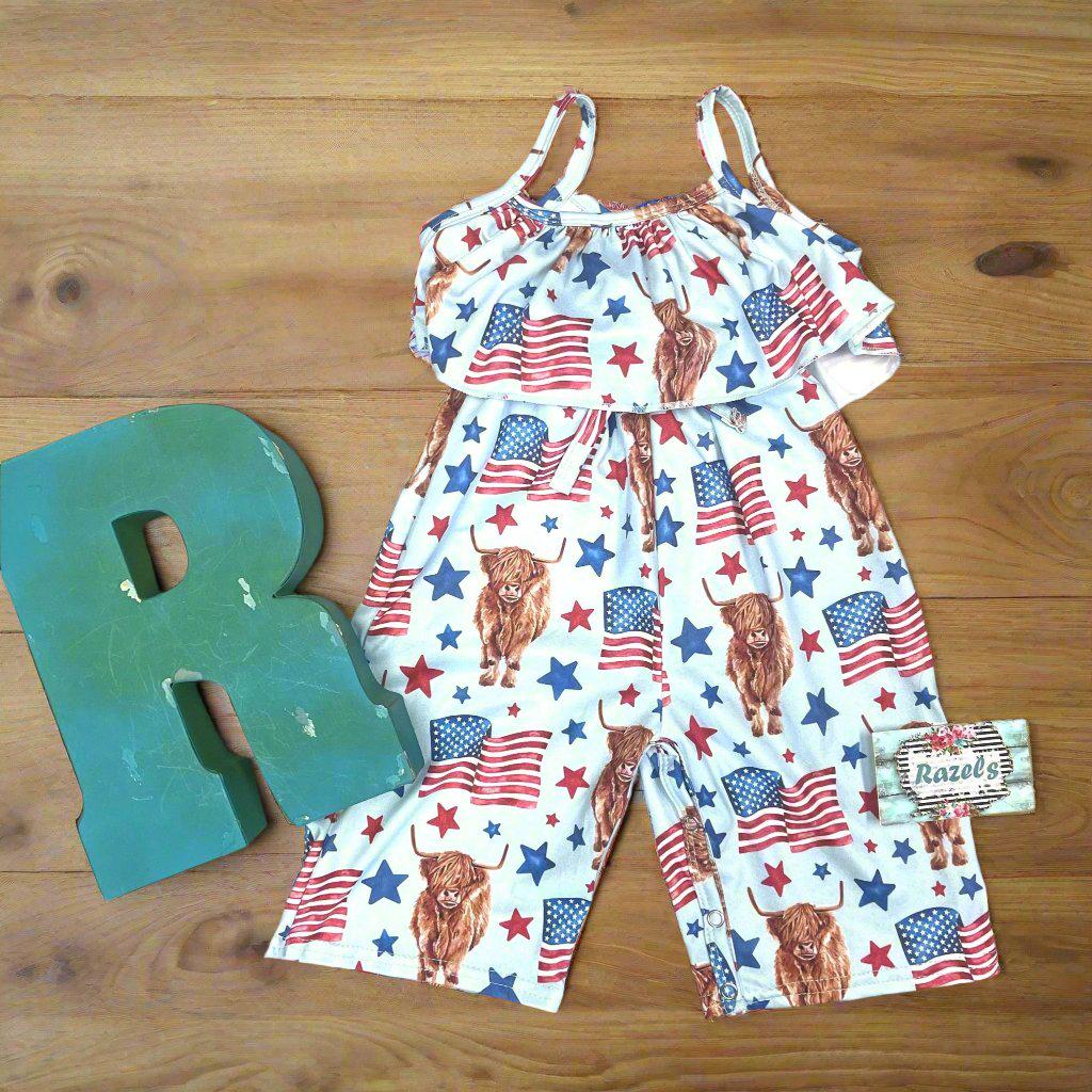 Get ready to celebrate the 4th of July in full-on Western style with our adorable Highland Cow & American Flag ROMPER WITH A SPAGHETTI STRPAS, RUFFLED NECKLINE AND CAPRI LENGTH PANTS ON A WOODEN BACKGROUND WITH RAZELS LETTER R