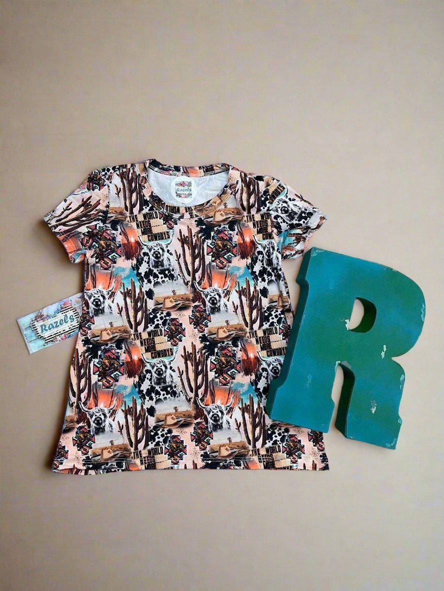 FLAT LAY OF girls The World Needs More Cowboys; t-shirt dress AGAINST BEIGE BACKGROUND WITH RAZELS BUSINESS CARD AND LARGE TURQUOISE R