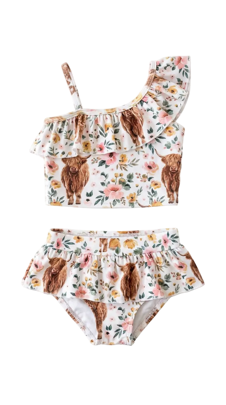 Two-piece swimsuit with scottish highlander cows and floral pattern on a white background