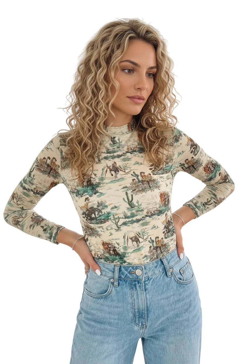 Woman wearing a VINTAGE COWBOY DESERT SCENE patterned long-sleeve top and jeans AGAINST WHITE BACKGROUND