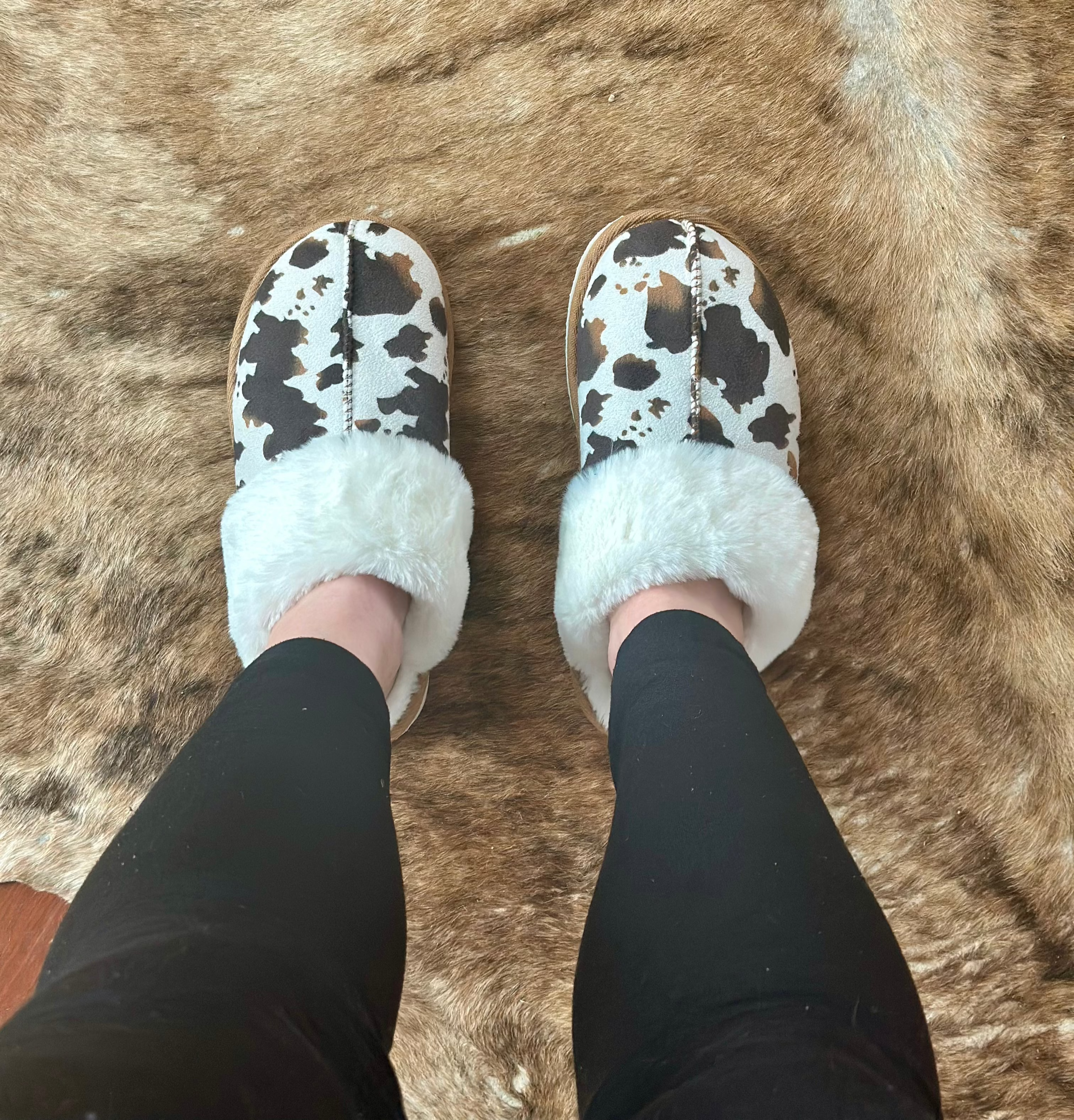 WOMEN'S COWPRINT SLIPPERS FEATURE THE SOFTEST PLUSH INSIDES AND RUBBER SOLES FOR INSIDE AND OUTSIDE WEAR.