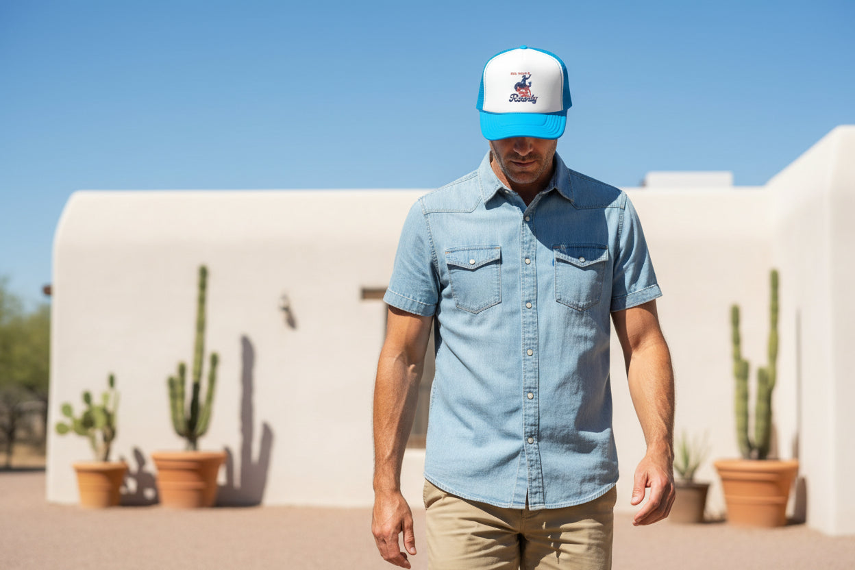 man wearing blue foam cowboy trucker hat in desert scene Embroidered Cowboy Trucker Hat: Red White & Rowdy Rodeo Cap -Razels