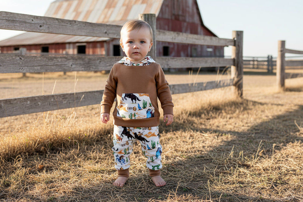Little Cowboy Outfit – Exclusive to Razels!

Get your little cowboys ready for adventure with this Boys Western Outfit, the perfect blend of style and comfort! This playful set features a lightweight hoodie sweatshirt with a convenient kangaroo pocket and coordinating cowboy-print jogger pants. The retro cowboy design adds a fun and nostalgic vibe, making this outfit perfect for any little cowboy who loves to ride in style! 🤠 SHIPS FREE WITH $35 ORDER FROM MONTANA