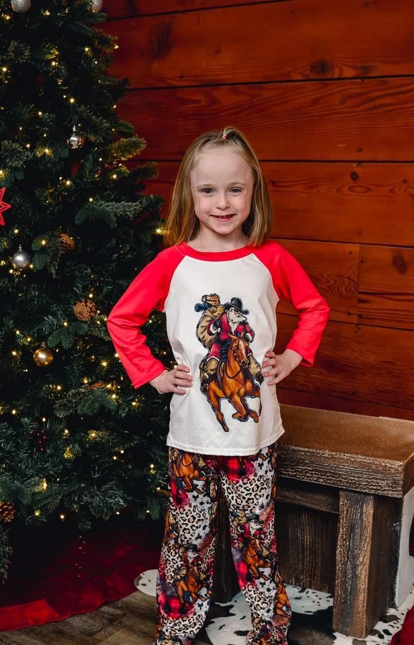 Cowboy Santa Christmas Pajamas featuring Santa riding his best horse in a collage of cheetah print, buffalo plaid and Cowboy Christmas spirit! PJ set in 3/6 months baby through adult 3x! Pajamas for EVERYONE!