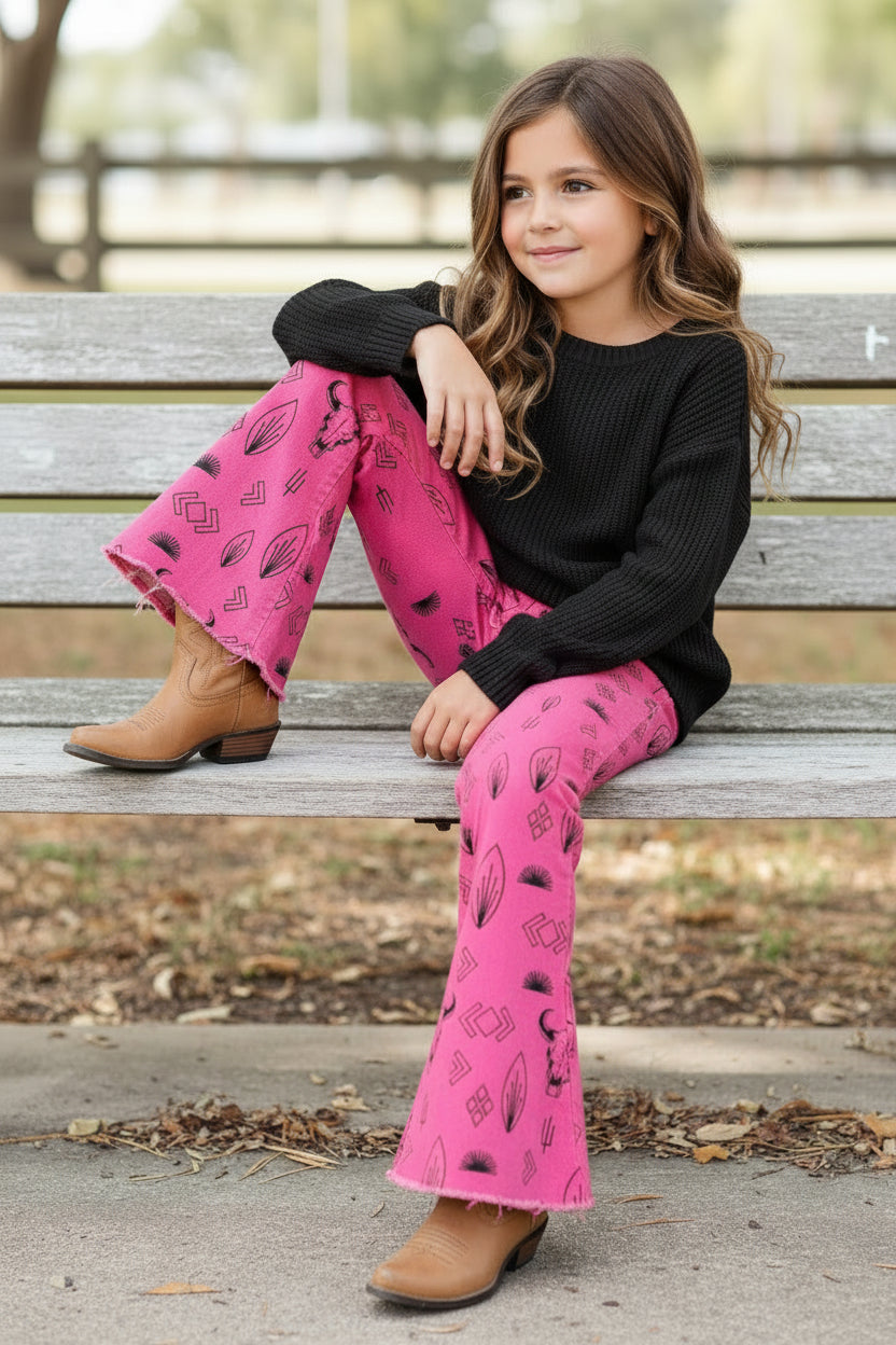 Girls Western Hot Pink Jeans. Jeans feature black steerheads, arrows, and cacti in an awesome western motif. Jeans have an adjustable waistband, pockets, and a frayed bell bottom hem.
