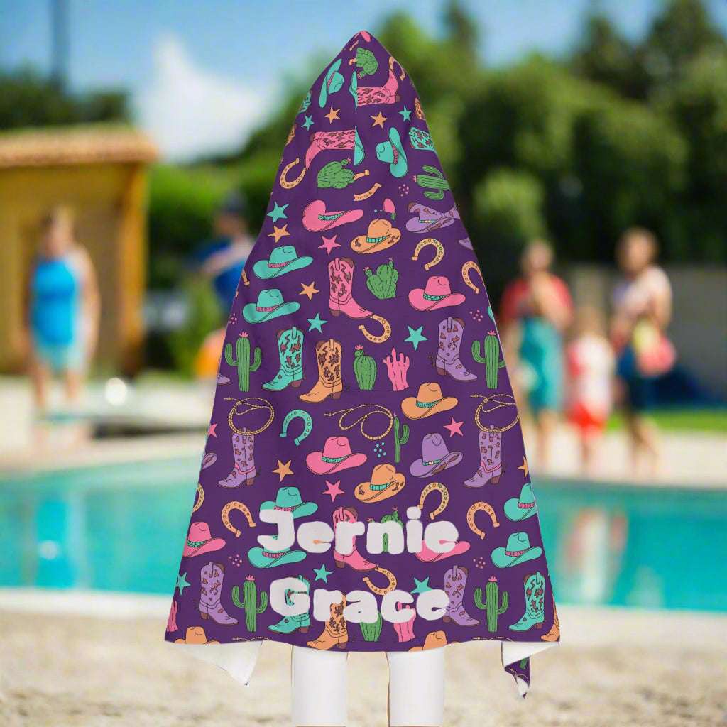 Cowgirl Hooded Towel for Kids – Personalized Western Towel in Pink, Purple & Turquoise
✓ FREE shipping on orders $35+
✓ Printed in the USA – usually arrives in 5–8 business days

Y’all ready for the cutest towel in the wild west? 🤠💖 This Cowgirl Hooded Towel features a vibrant mix of pink, purple, turquoise, and gold with adorable cowgirl hats, boots, cacti, stars, and lucky horseshoes. Whether it’s for the bath, pool, or beach, your little cowgirl will be wrapped in cozy comfort and western magic.

✓ Lin