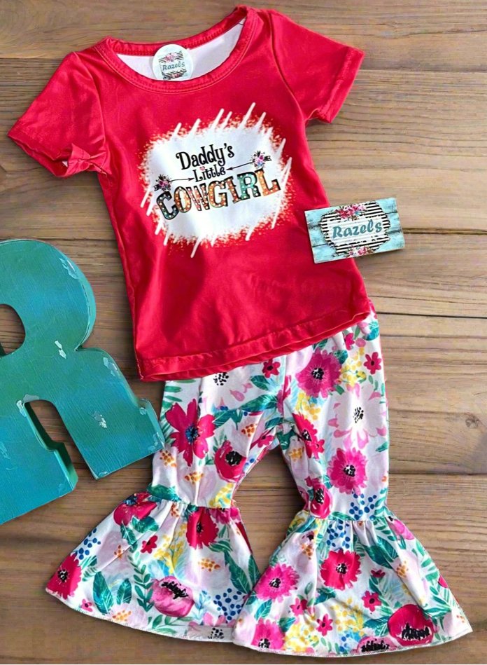 Daddy’s Little Cowgirl Bell Bottom Outfit | Girls Western T-Shirt & Flower Bell Bottom Pants Set. This adorable set features a red "Daddy's Little Cowgirl" graphic T-shirt paired with vibrant floral bell bottom pants for a fun, Western-inspired look.