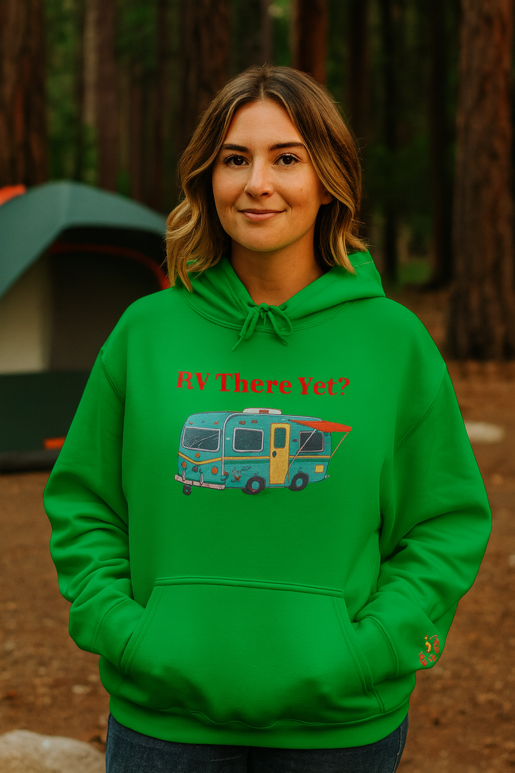 Person wearing a green hoodie with an RV graphic in a forest setting