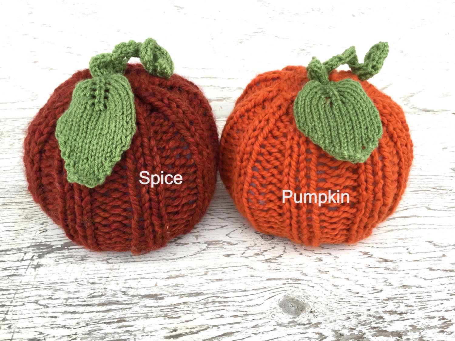 handknit large pumpkin with knit ribs along side, and a handknit leaf and vine sprouting from top! Cute!