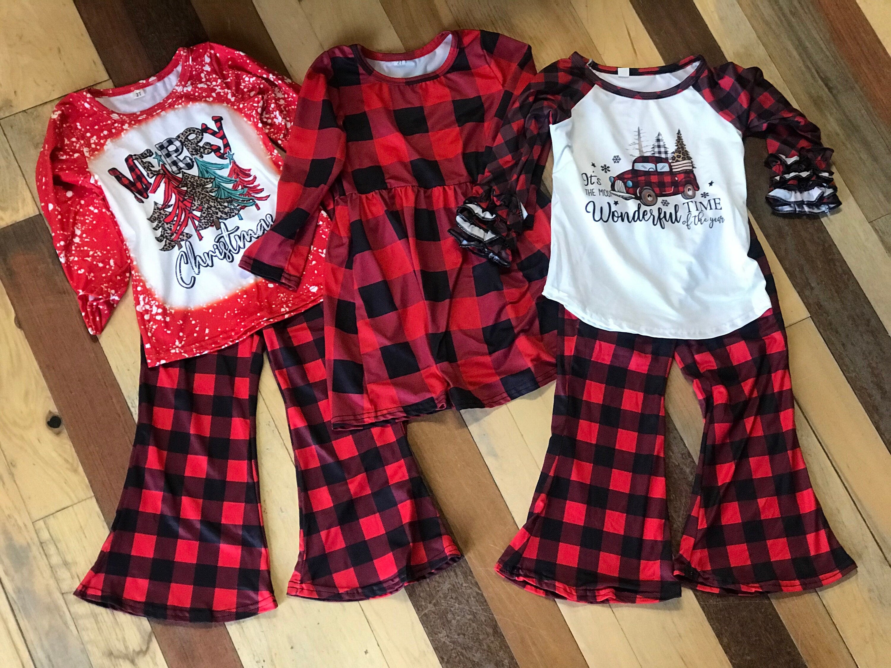 girls christmas outfits featuring red and black checkered buffalo plaid trouser pants and your choice of Merry Christmas or It&#39;s the Most Wonderful Time of the Year Long Sleeve Shirts