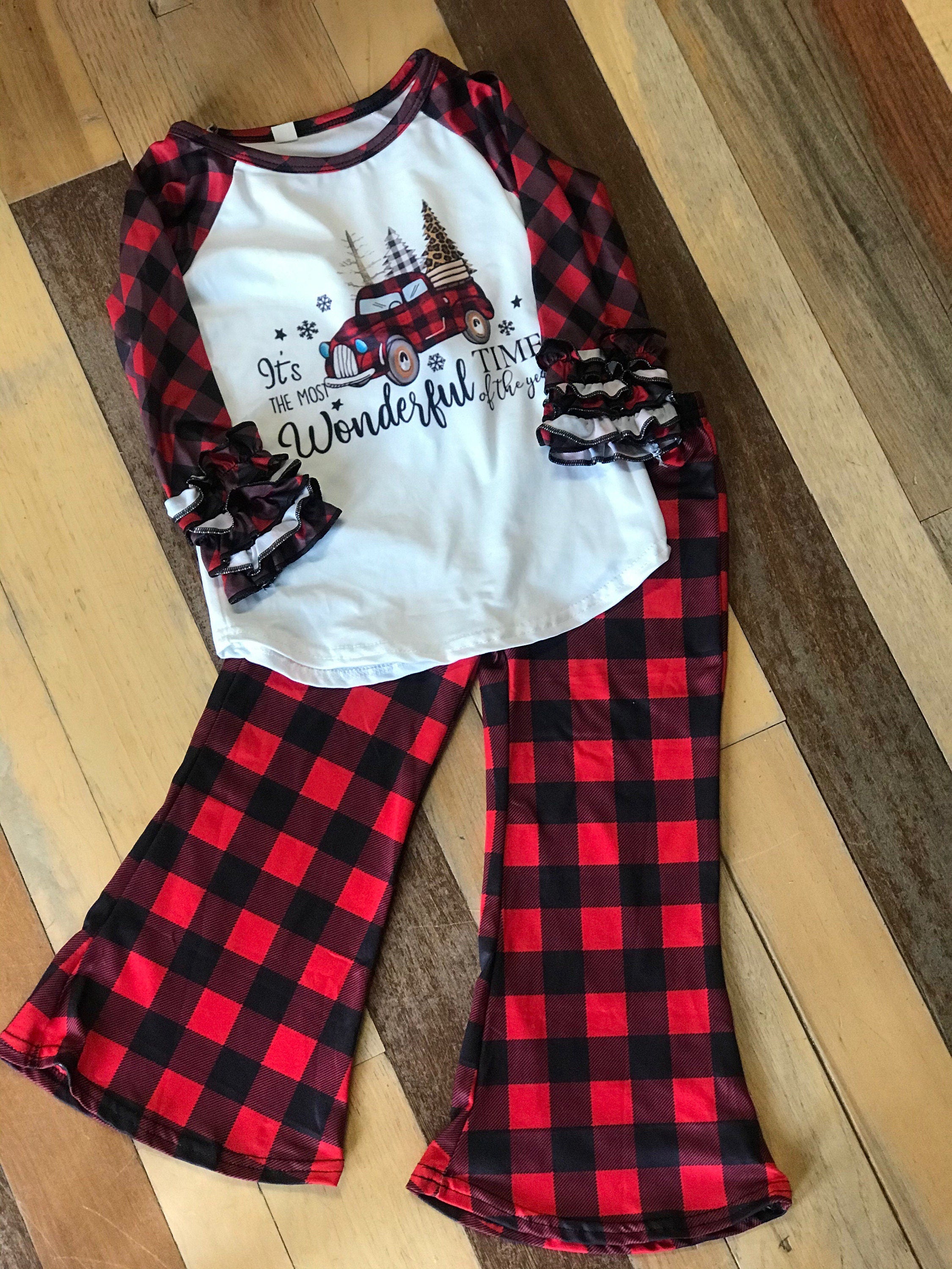 girls christmas outfits featuring red and black checkered buffalo plaid trouser pants and your choice of Merry Christmas or It&#39;s the Most Wonderful Time of the Year Long Sleeve Shirts