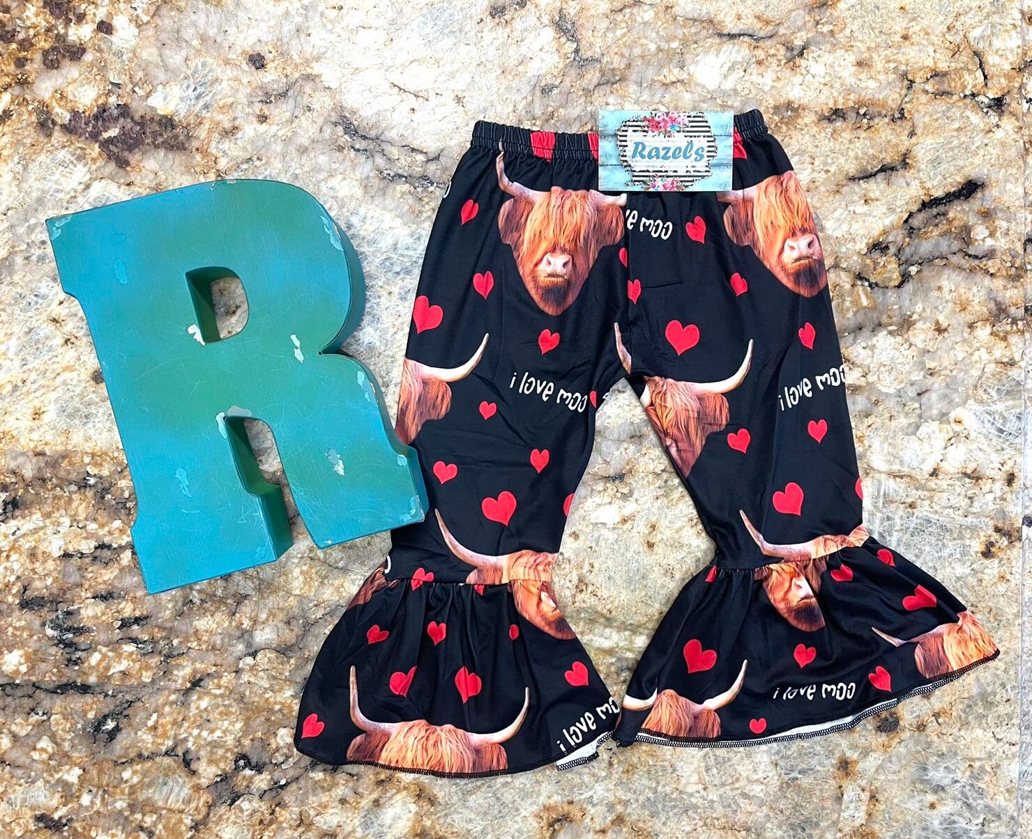 Girls Black bell bottom pants that feature Scottish highlander cows, red hearts and the words I Love MOO