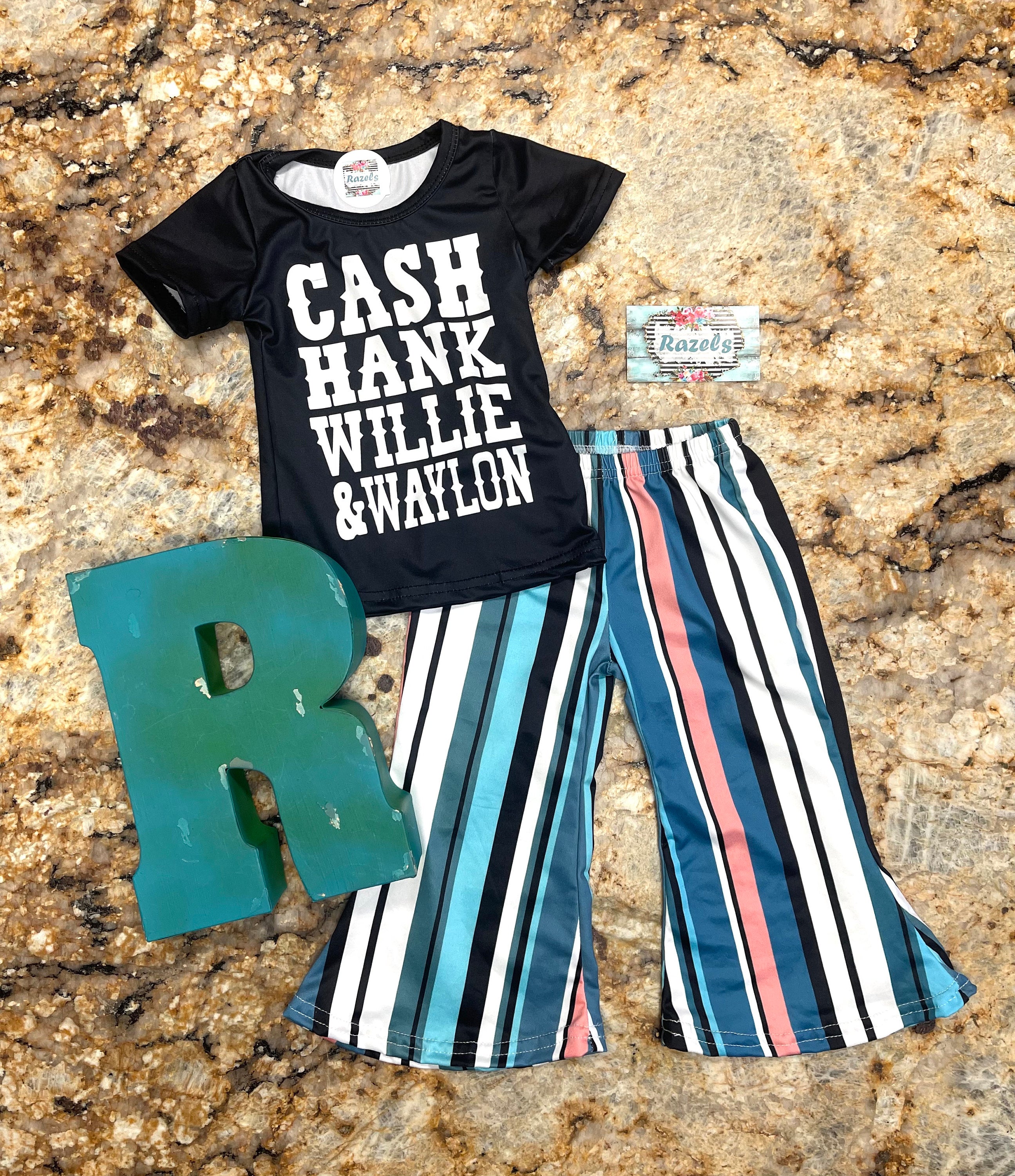 Girls Country Music bell bottom outfit. The outfit features black t-shirt with CASH, HANK, WILLIE, AND WAYLON scrolled across the front. Bell bottom pants feature stripes in pink, blue, black, white and turquoise.